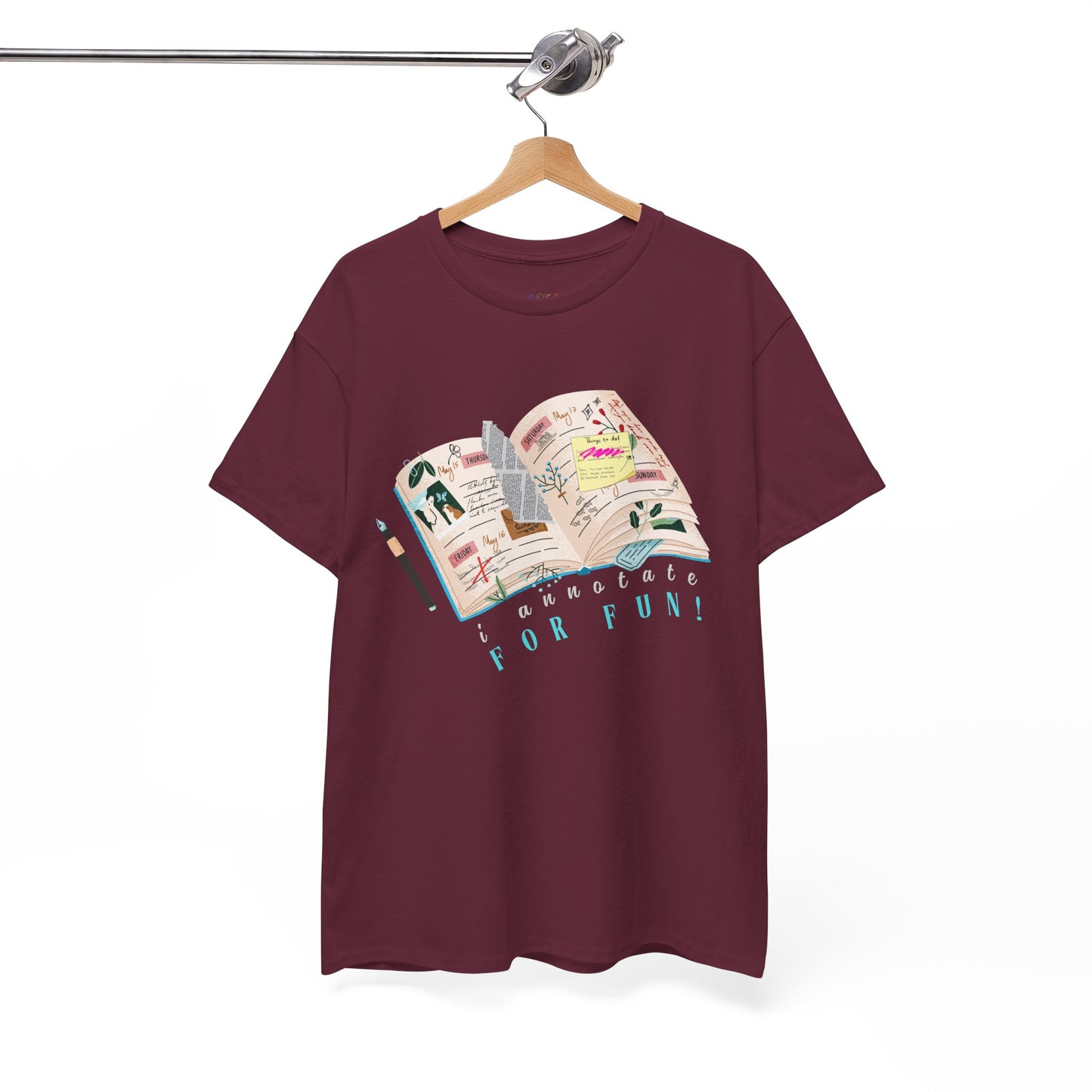 Maroon t-shirt with a An open scrapbook full of scribbles, tickets, newspaper clippings and more, text 'I Annotate For Fun' 