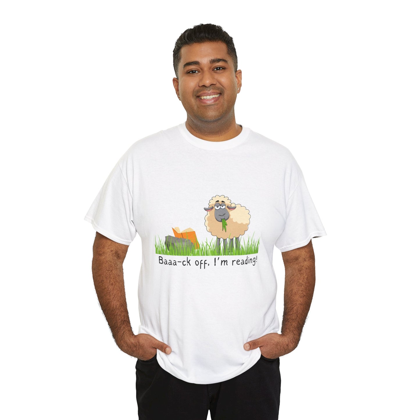 Man wearing a white t-shirt with a sheep munching grass and reading a book propped up on a rock, text 'Baaa-ck off. I'm Reading!'