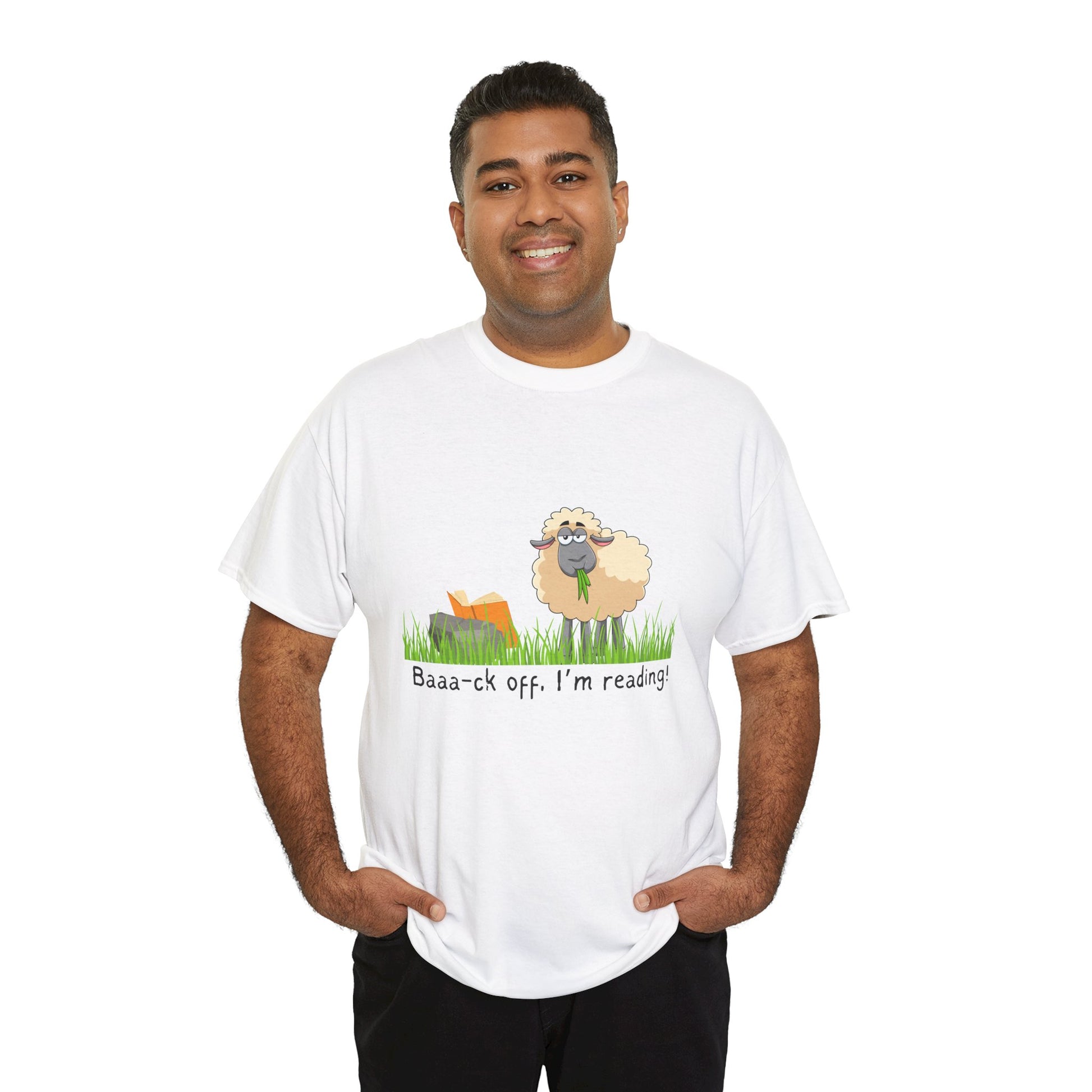 Man wearing a white t-shirt with a sheep munching grass and reading a book propped up on a rock, text 'Baaa-ck off. I'm Reading!'