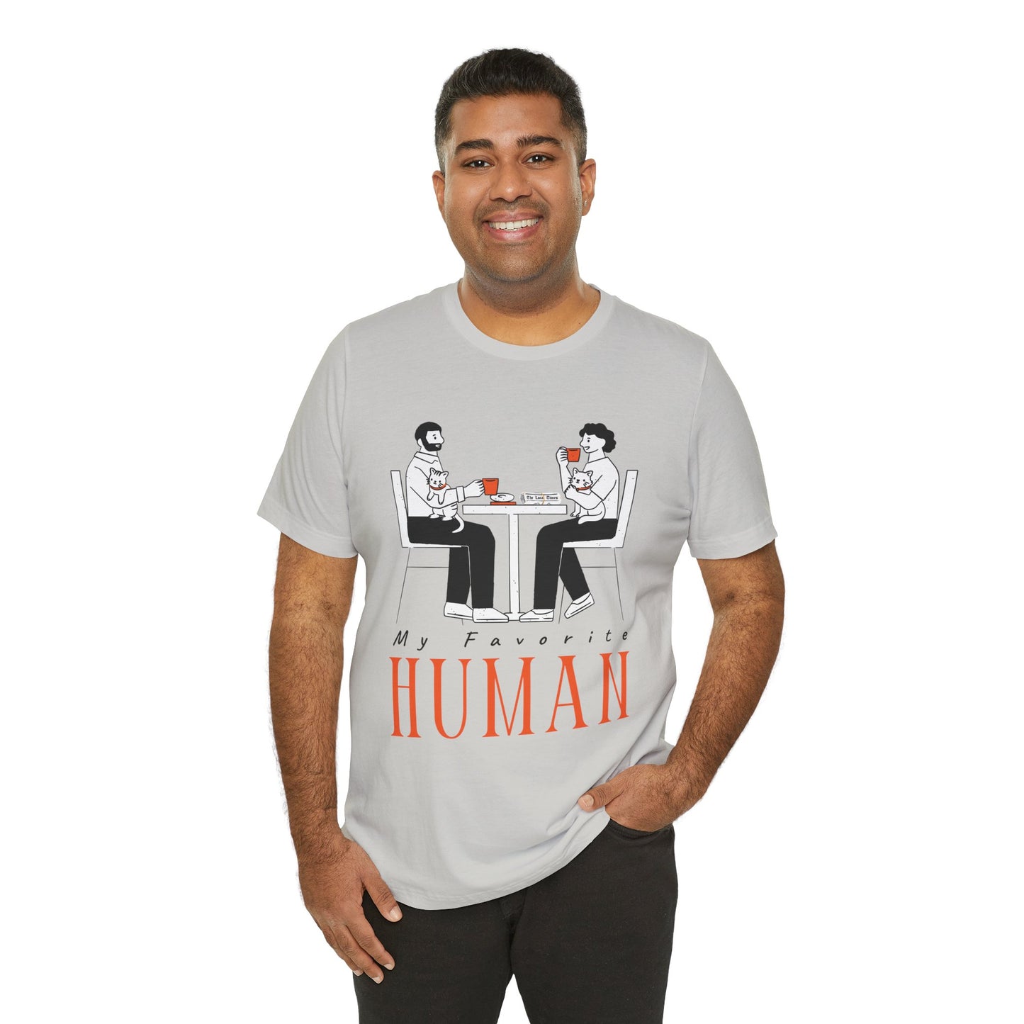 Man wearing a gray t-shirt with a graphic of two people sitting at a table, newspaper in front of one, drinking hot beverages, holding cats and text 'My Favorite Human' 