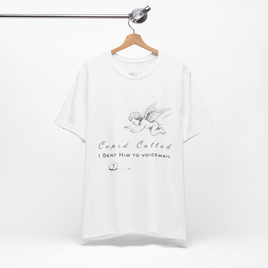 White t-shirt with cupid graphic design, a broken heart on the floor and text 'Cupid Called. I Sent Him To Voicemail.'
