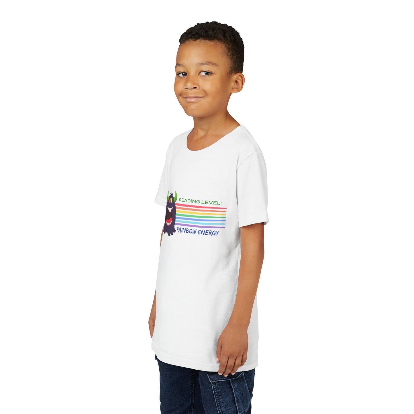 Boy wearing a white t-shirt with a cartoon monster, horizontal rainbow strips and text 'Reading Level: RAINBOW ENERGY' 