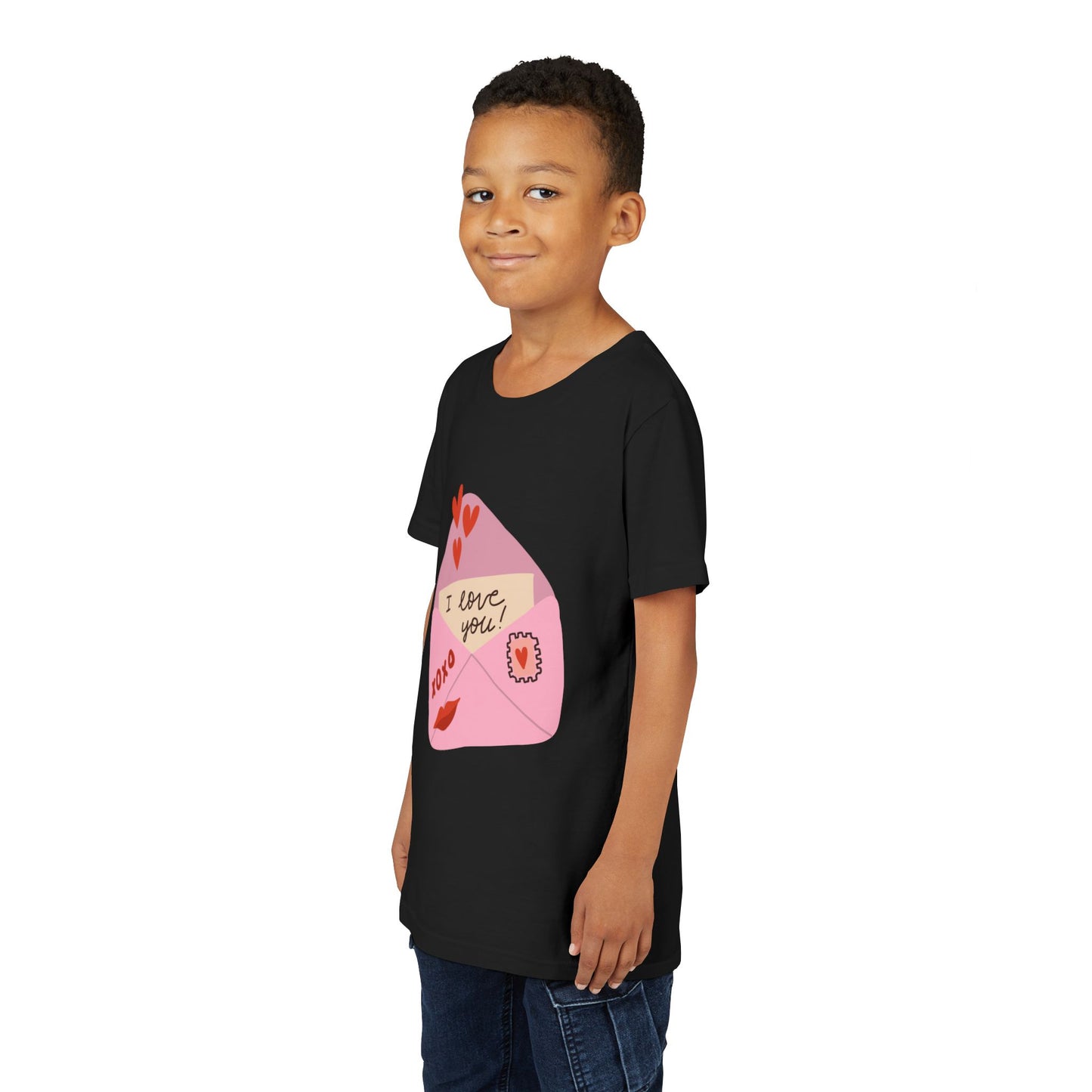 Boy wearing a black t-shirt with an 'I love you!' letter peaking out of a pink envelope