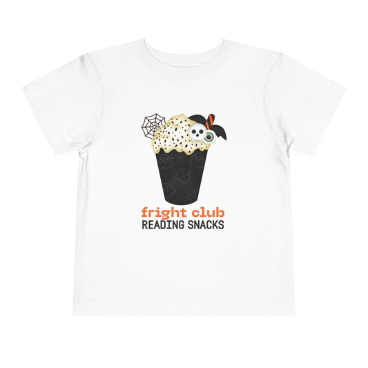 White t-shirt with Halloween-themed  foamy beverage design and text "fright club reading snacks' on a white background