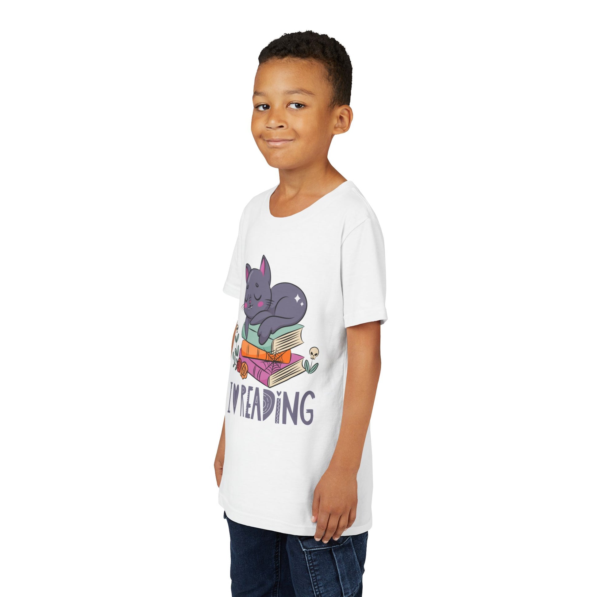 Boy wearing a white t-shirt with a cat snoozing on a stack of books and 'I love reading' text 