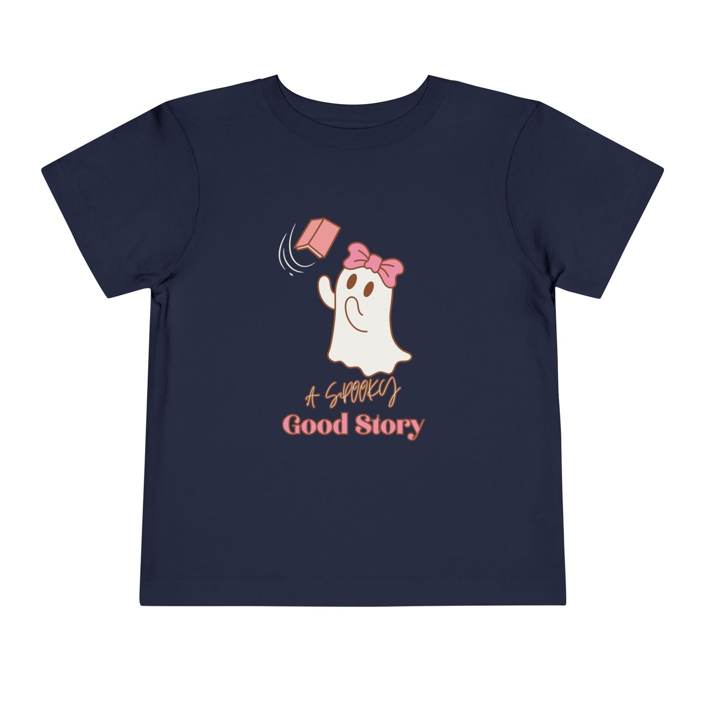 Navy toddler t-shirt with a ghost trying to catch a floating pink book with text 'A SPOOKY GOOD STORY'