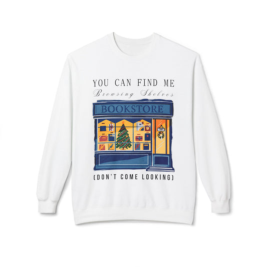 White sweatshirt with a graphic of a bookstore, Christmas tree in the window and text 'You Can Find Me Browsing Shelves (Don't Come Looking)'