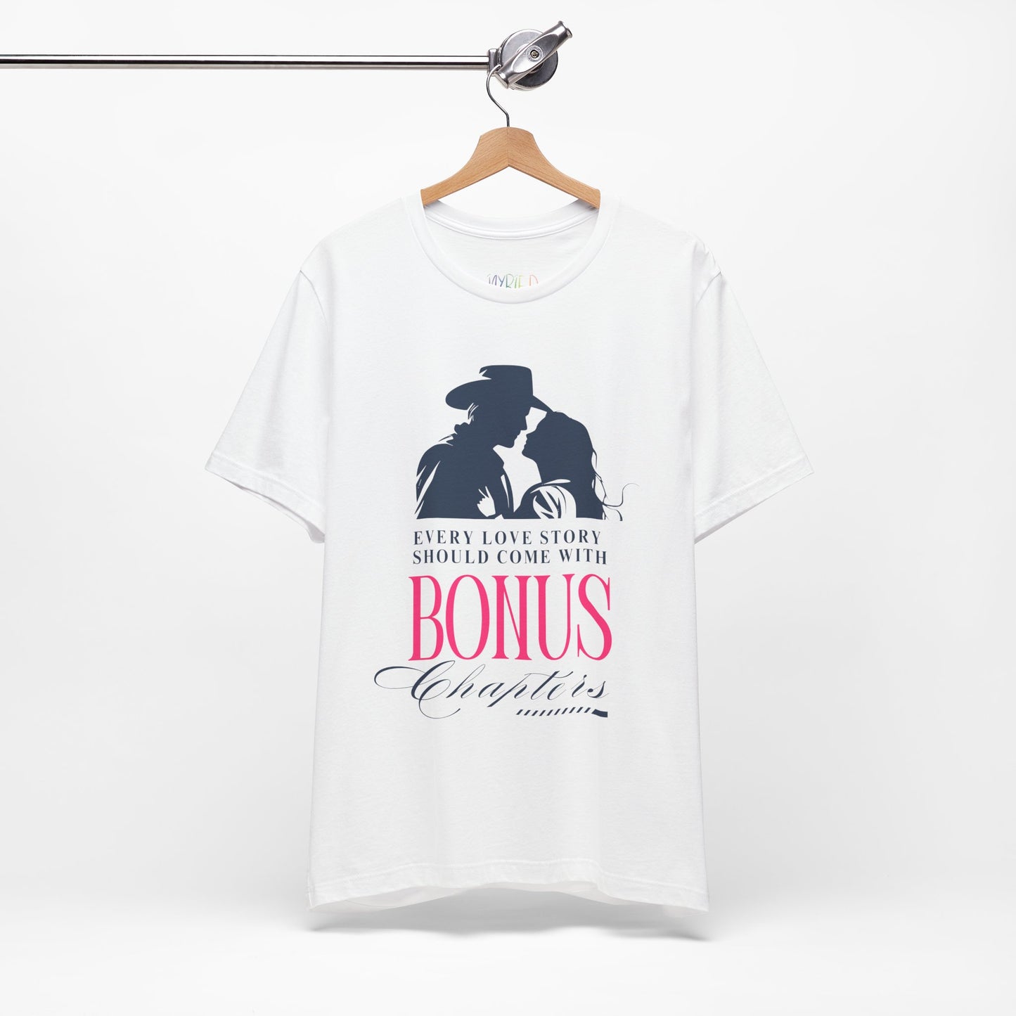 White t-shirt with western graphic of a man and woman leaning in for a kiss, text "Every Love Story Should Come With BONUS Chapters'