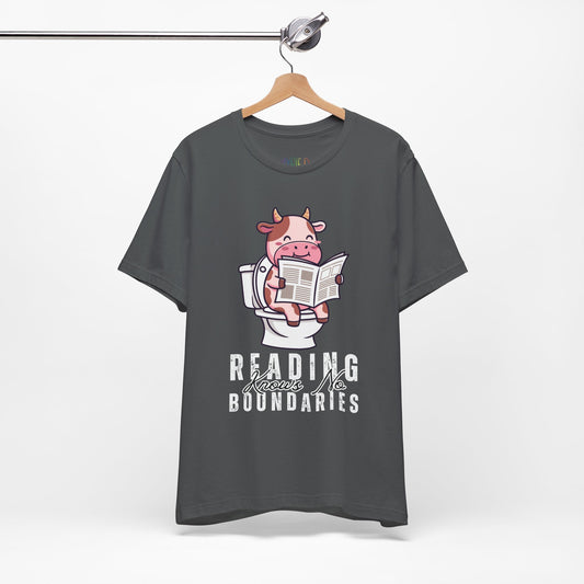 Gray t-shirt with a graphic of a cow on a toilet reading a newspaper, with text 'Reading Knows No Boundaries', 
