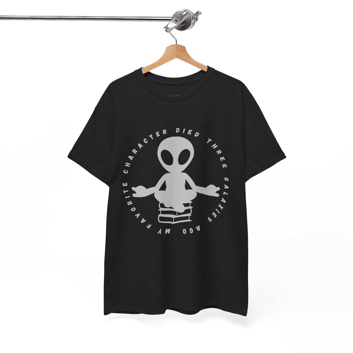 Black t-shirt with meditating alien sitting on a stack of books, circled by text 'My Favorite Character Died Three Galaxies Ago' 