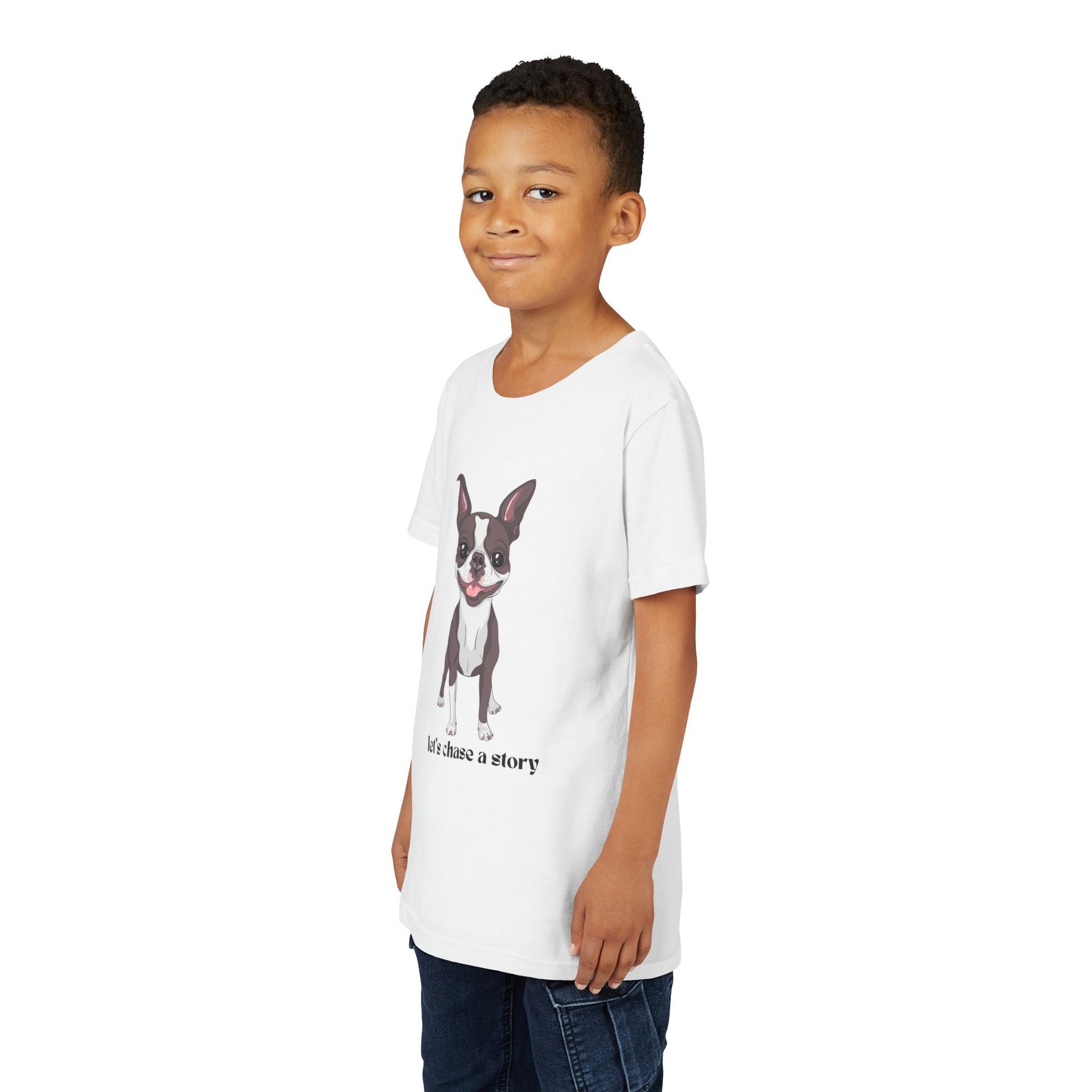 Boy wearing a white t-shirt with a cut dog and text 'let's chase a story'