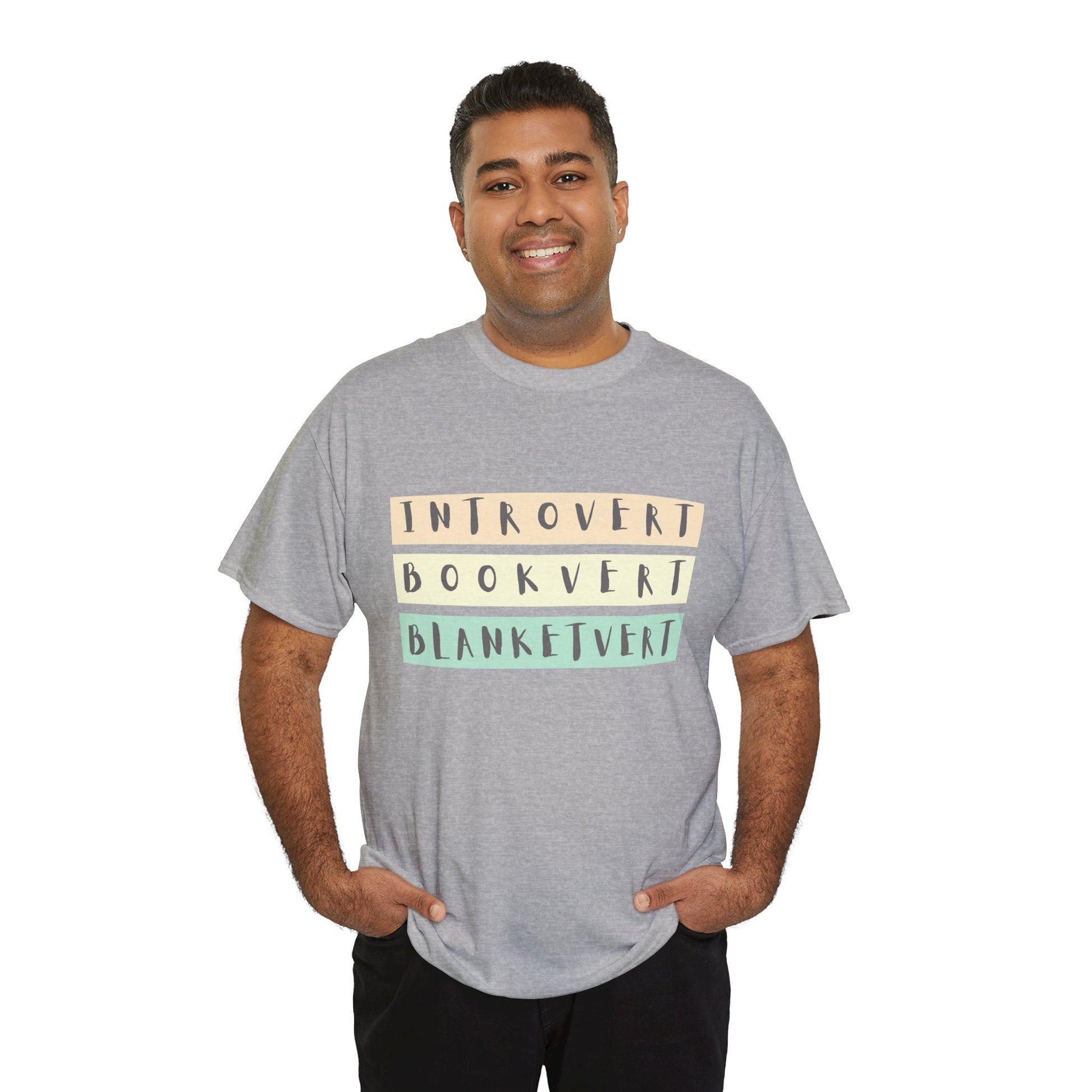Man wearing a gray t-shirt with soft colorful text 'Introvert. Bookvert. Blanketvert.'