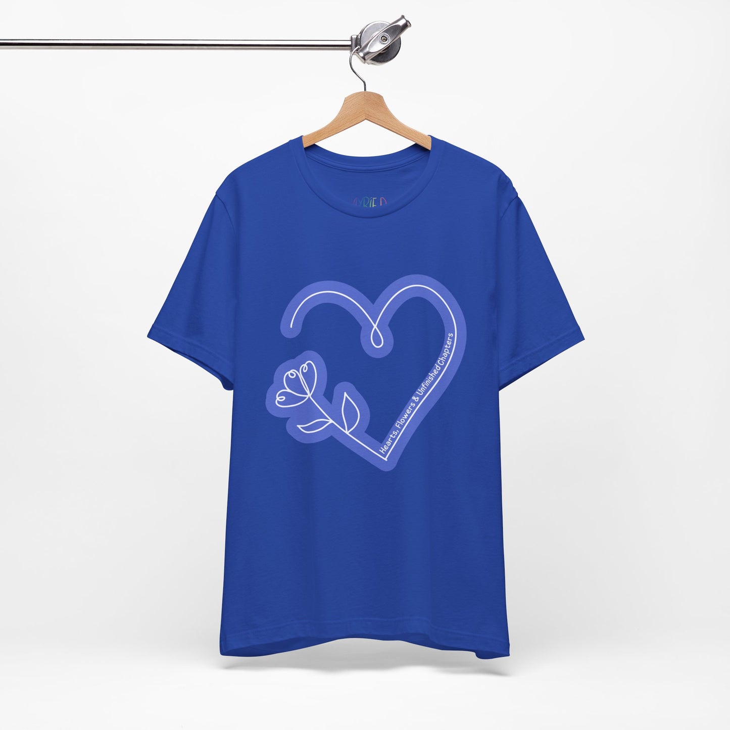 Blue t-shirt with a light blue heart and flower sketched design and text 'Hearts, Flowers & Unfinished Chapters'
