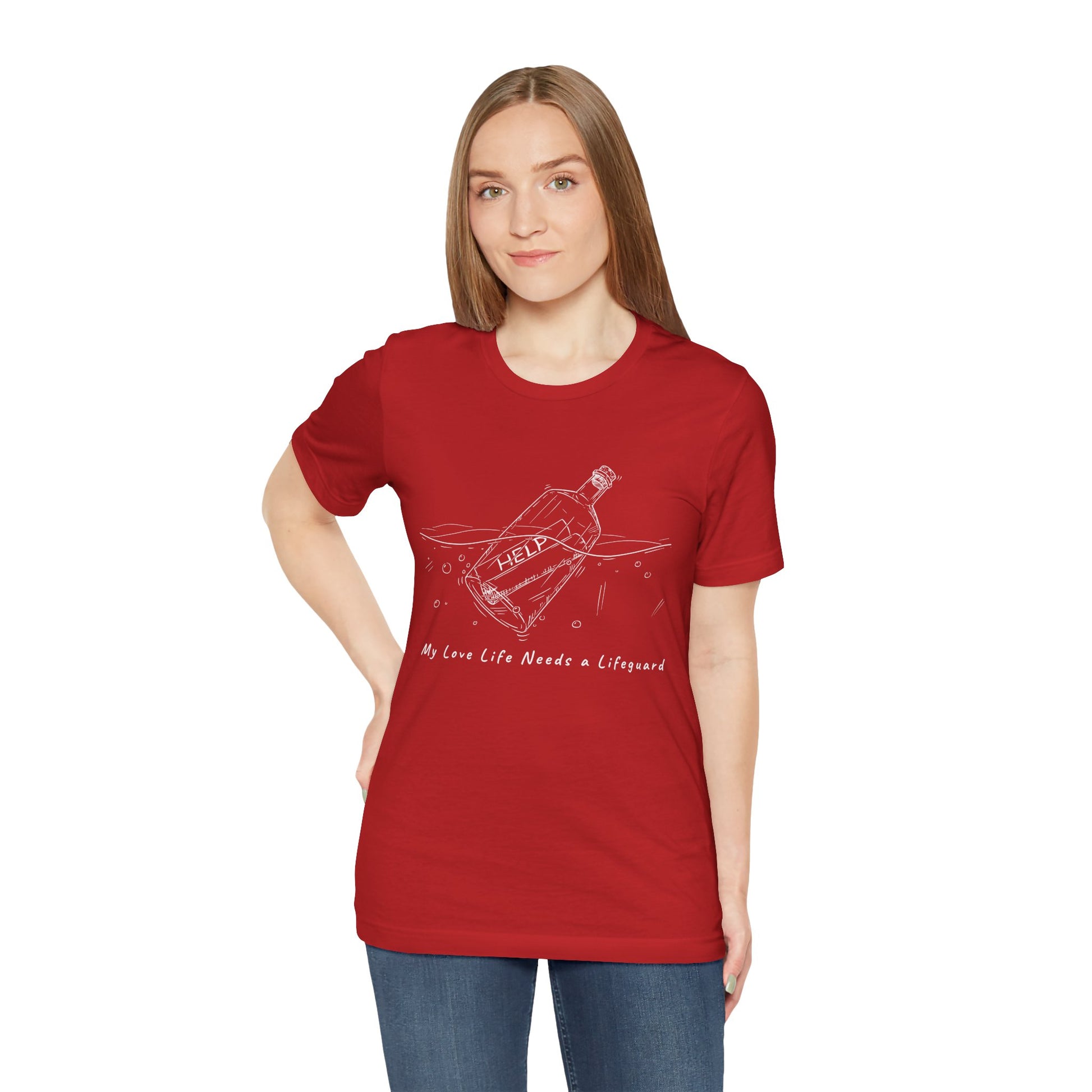Woman wearing a red t-shirt with white sketched image of a bottle floating in water with a rolled up paper inside that says 'help' and text below 'My Love Life Needs a Lifeguard'
