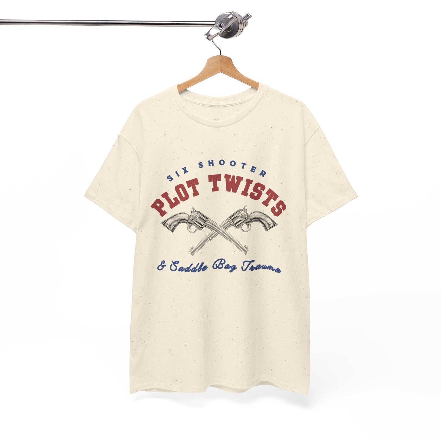 Beige t-shirt with two pistols criss-crossed in the center and text 'Six Shooter Plot Twists & Saddle Bag Trauma'
