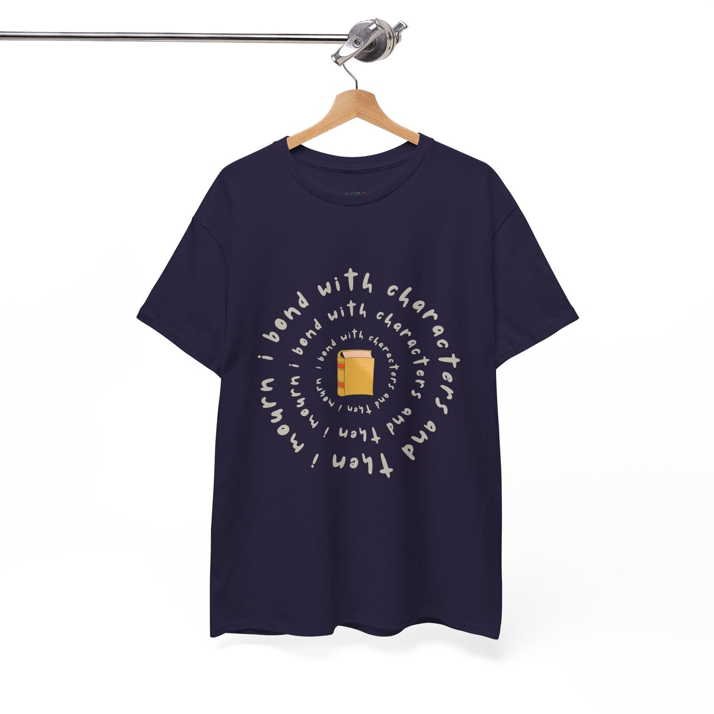 Dark t-shirt with a small book at the center and layered spiral text 'I Bond With Characters & Then I Mourn'