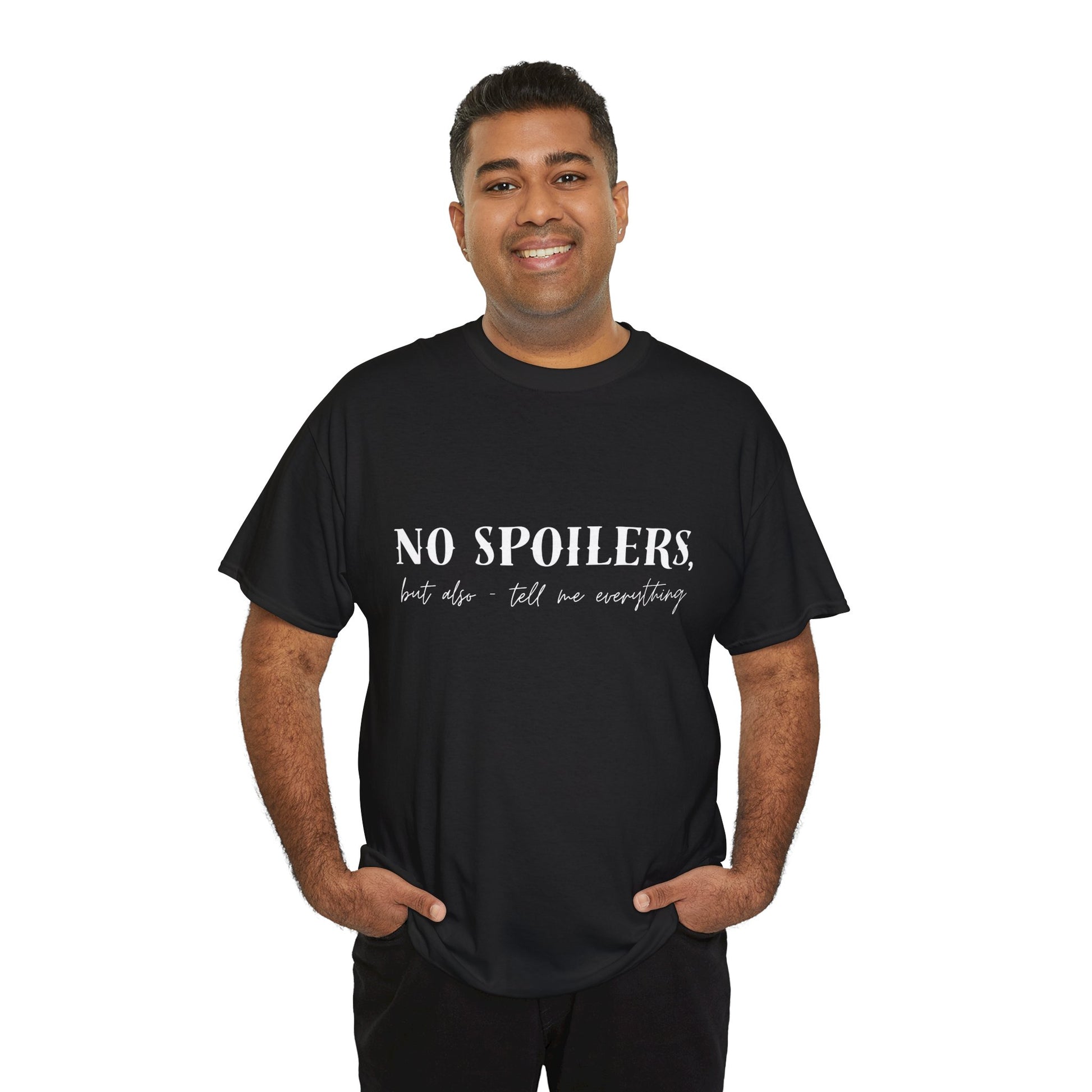 Man wearing a black t-shirt with white text 'NO SPOILERS, but also tell me everything' 