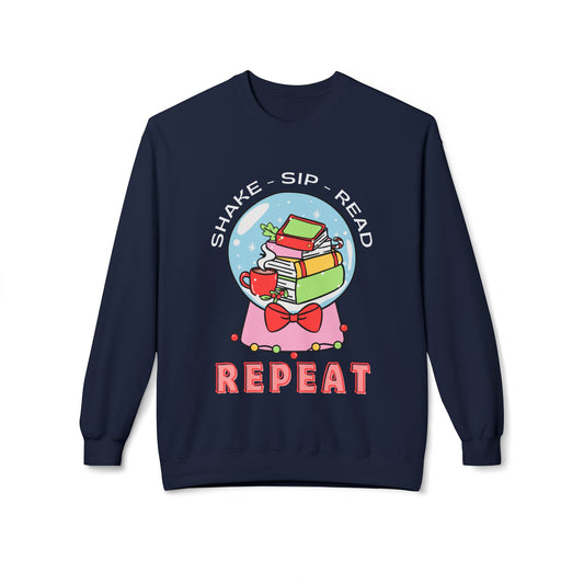 Navy blue sweatshirt with a graphic of books, a teacup, and a bow tie in a snow globe, with text 'Shake, Sip, Read, Repeat' on a white background.