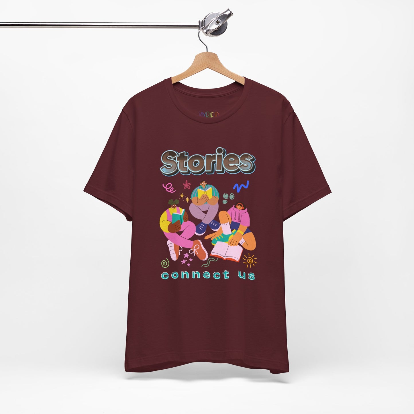 Maroon t-shirt with colorful modern people reading, surrounded by doodles, and text 'Stories connect us' 