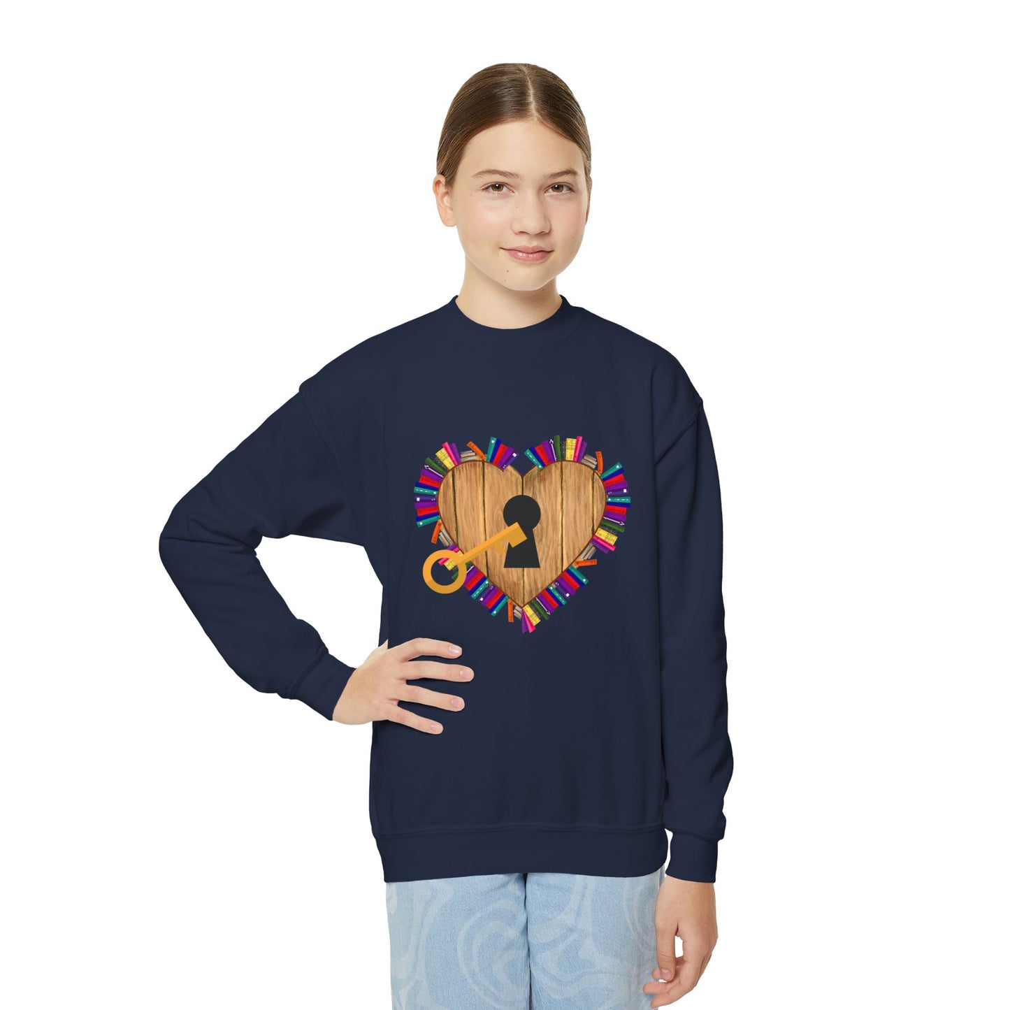 Girl wearing a navy blue sweatshirt with a wooden heart lock and key surrounded by tiny books