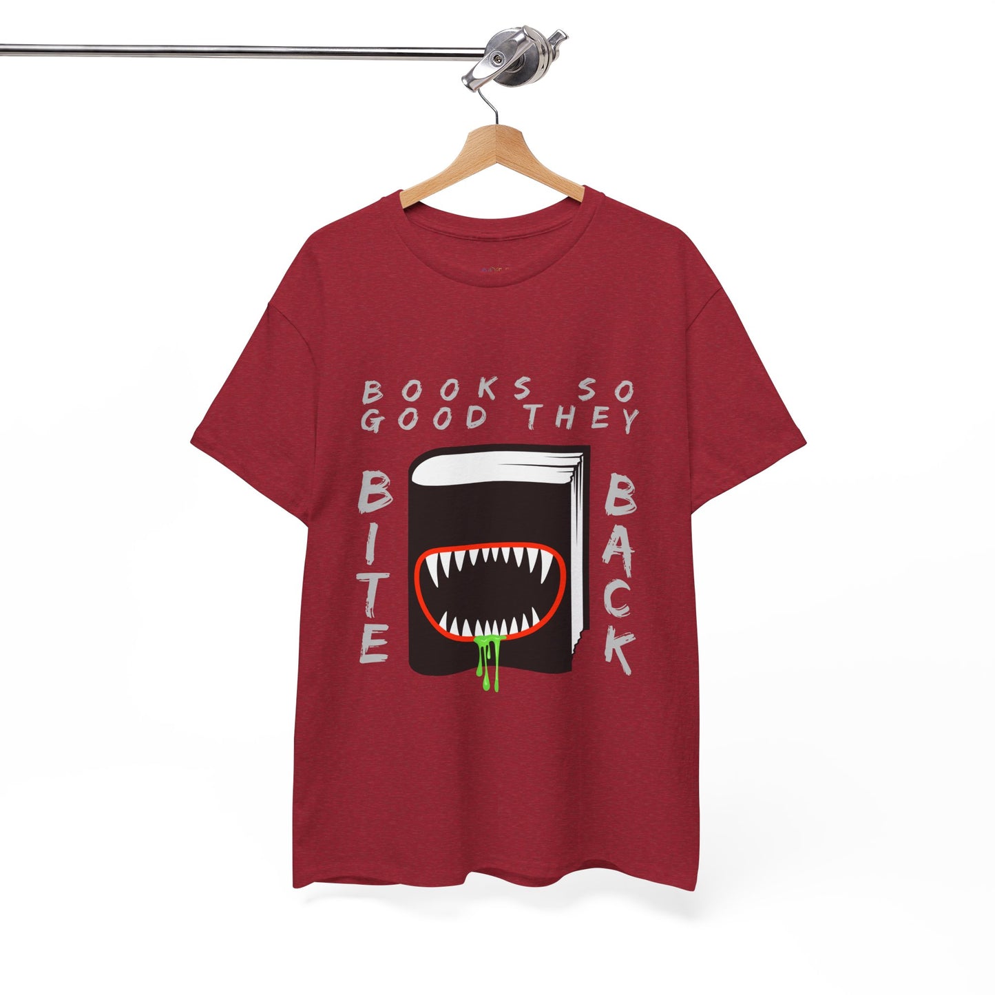 Red t-shirt with a graphic design of a book with a drooling monster mouth and text 'Books So Good They Bite Back' on a hanger against a white background