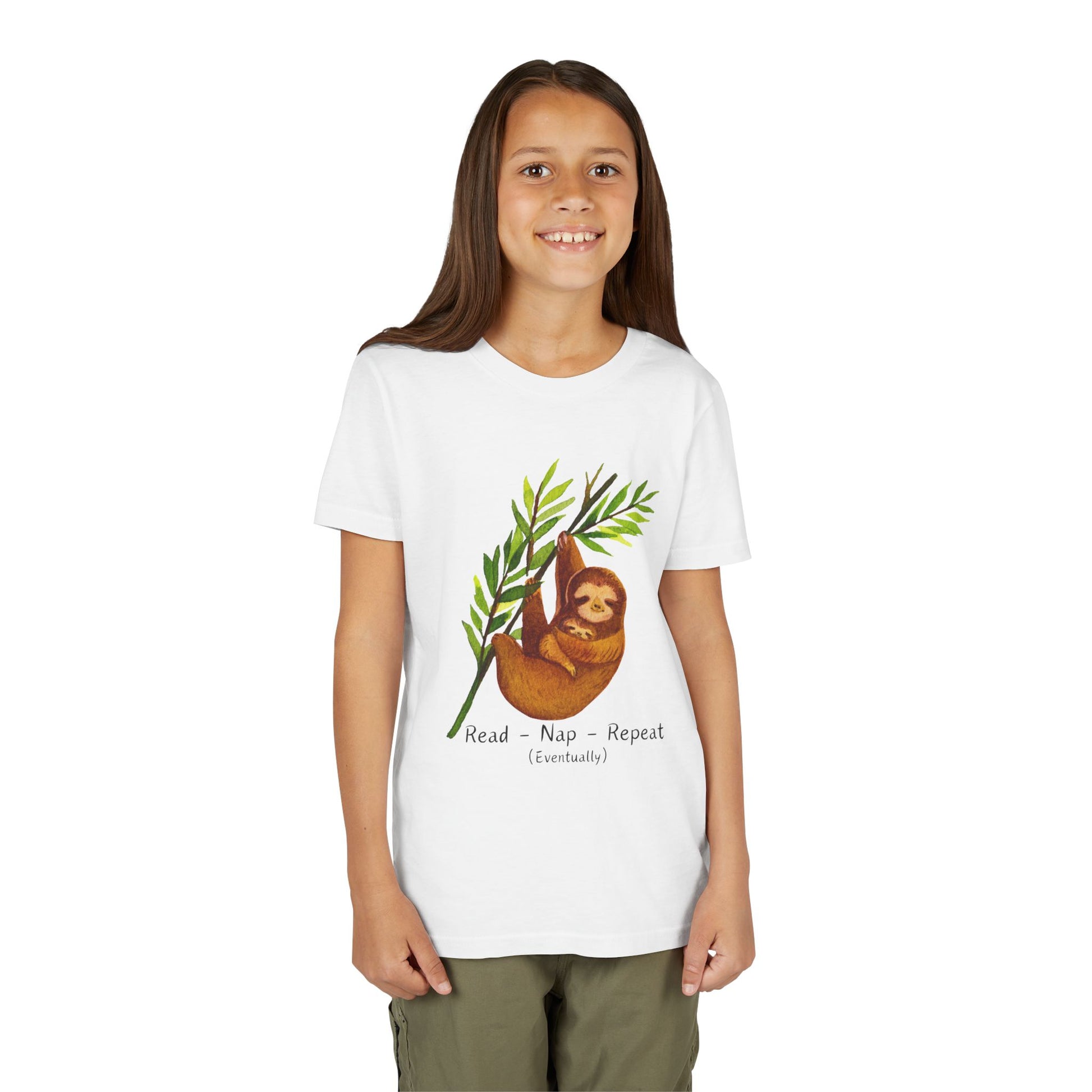 Girl wearing a white sloth t-shirt with a and text 'Read. Nap. Repeat. (Eventually)'