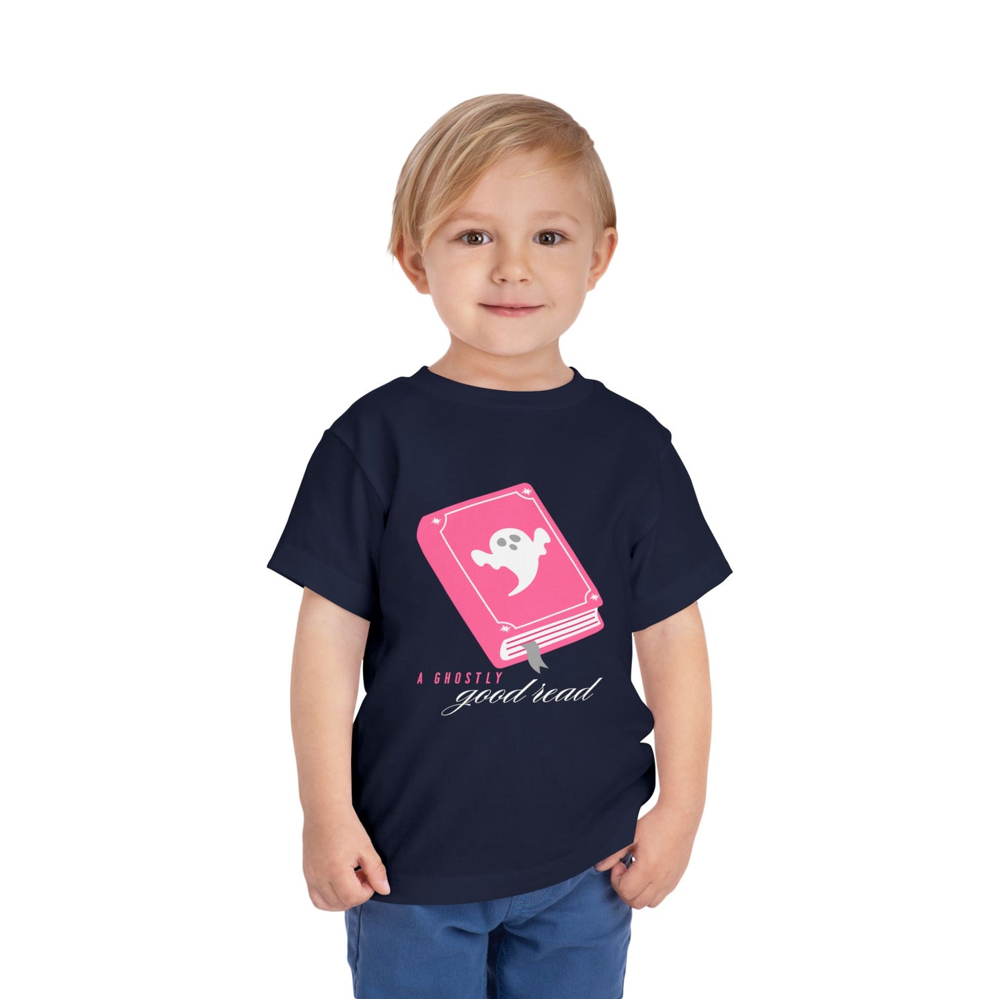 Toddler wearing a navy blue t-shirt with pink book with a ghost on the cover and text 'A ghostly good read' 