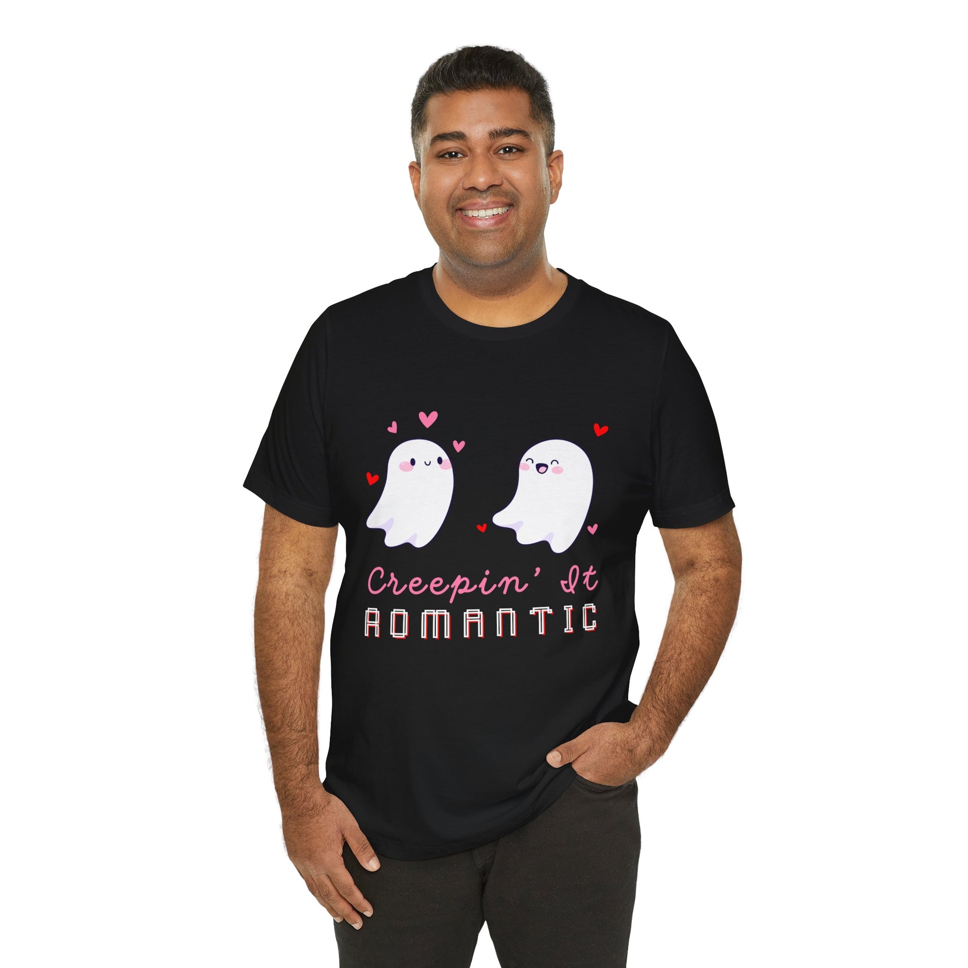 Man wearing a black t-shirt with two flirty ghosts, scattered hearts and text 'Creepin' It Romantic' 