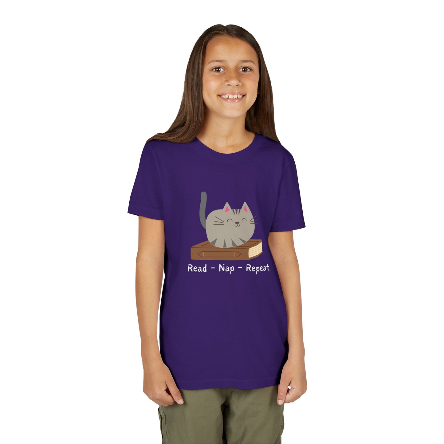 Girl wearing a purple t-shirt with a cat sitting on a book and text 'Read - Nap - Repeat' 