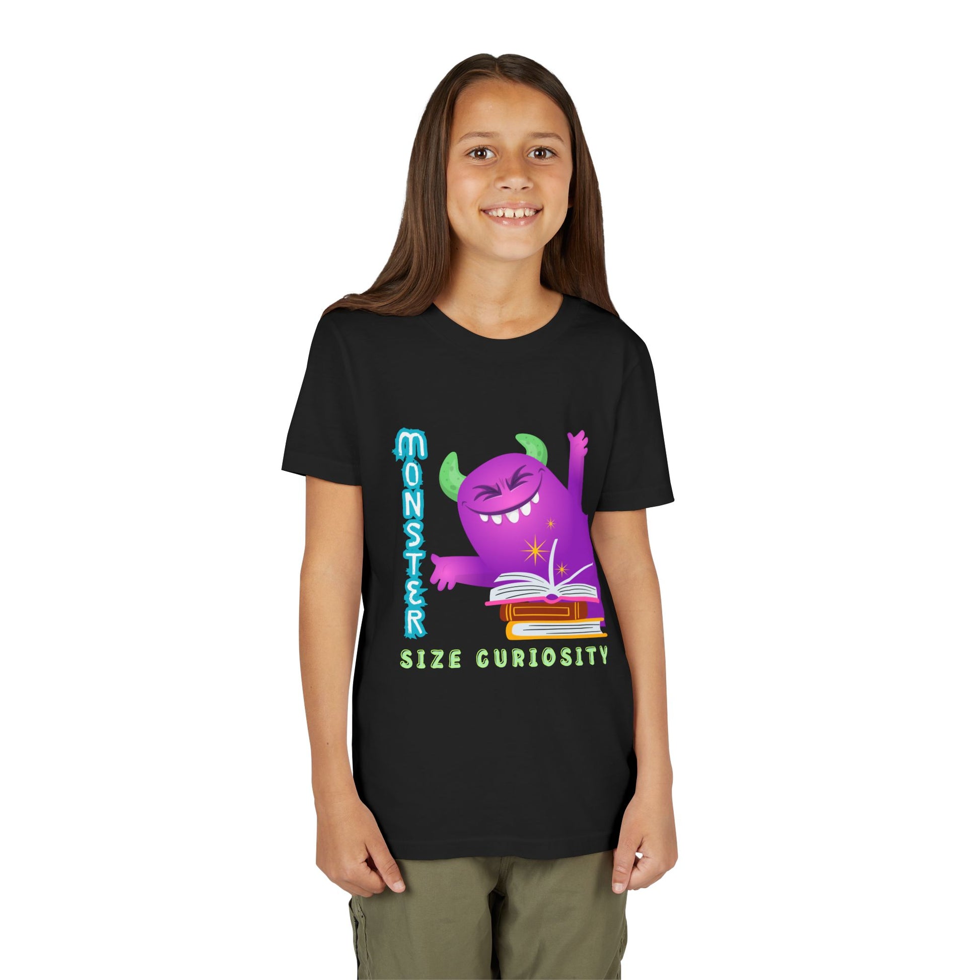 Girl wearing a black t-shirt with a purple monster leaning in from the edge of the page, a stack of books and text 'Monster Size Curiosity' 