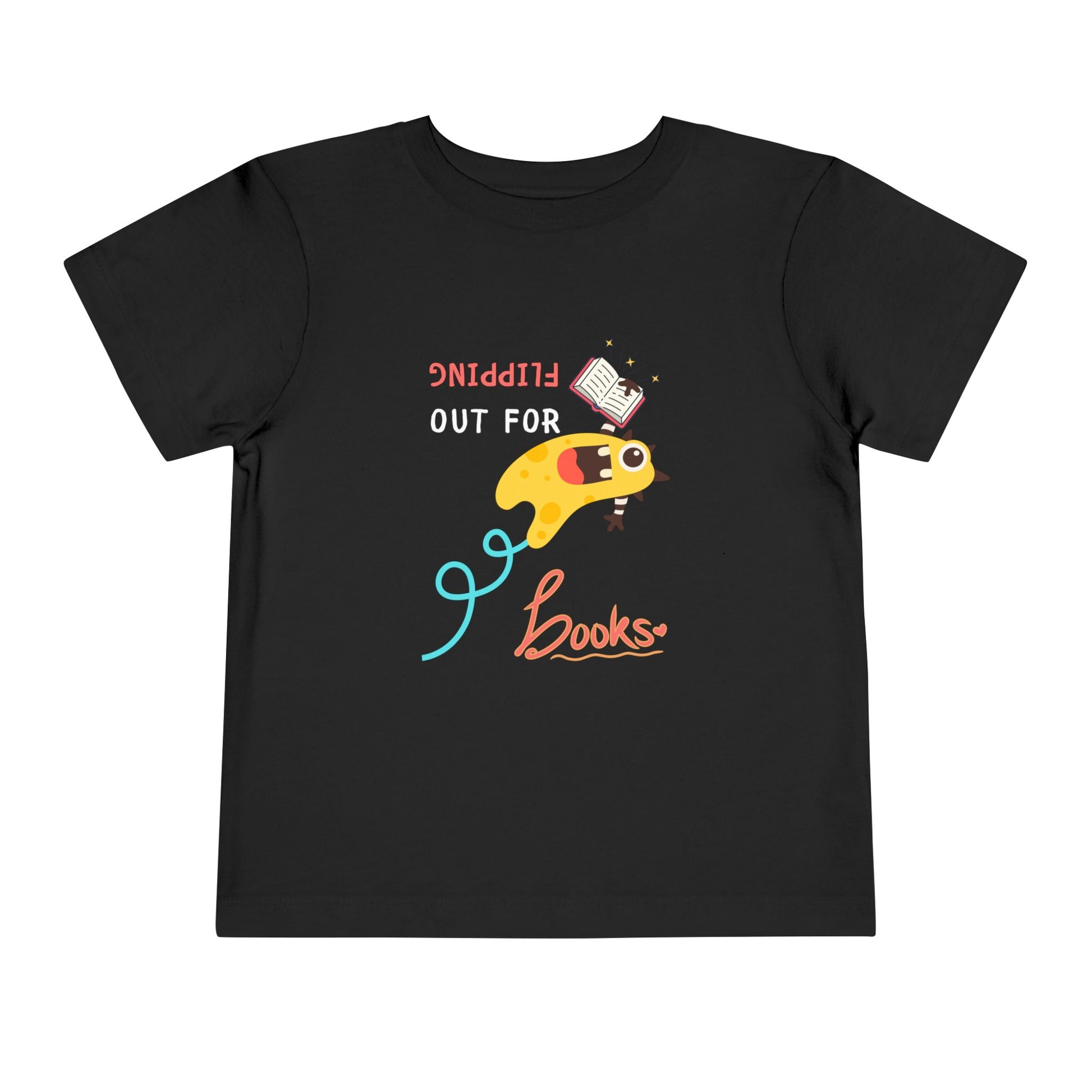 Black toddler t-shirt with a yellow monster flipping backwards through the air while holding a book and playful text "FLIPPING OUT FOR BOOKS'