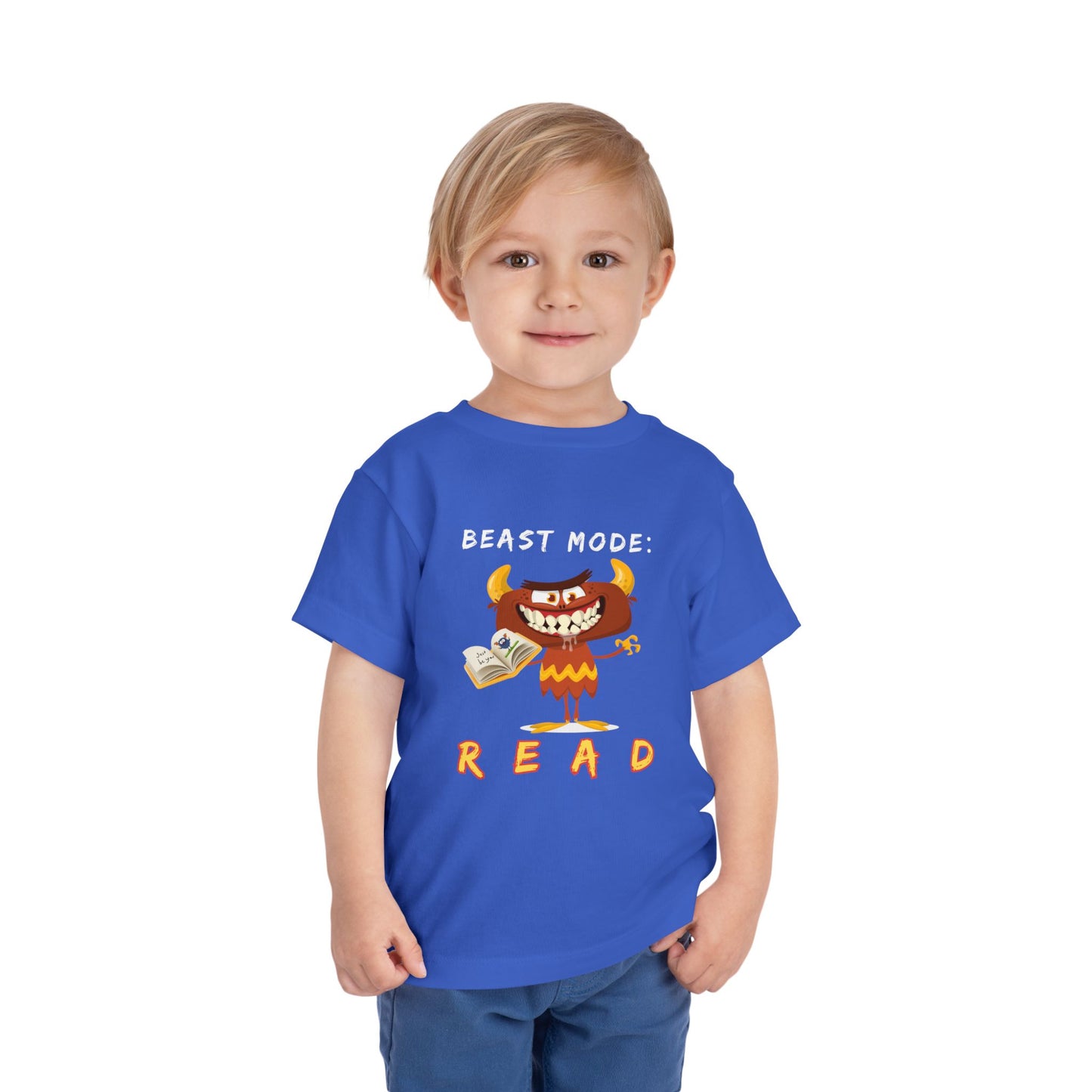 Child wearing a blue toddler t-shirt with a drooling cartoon monster holding a book and text 'Beast Mode: Read' 
