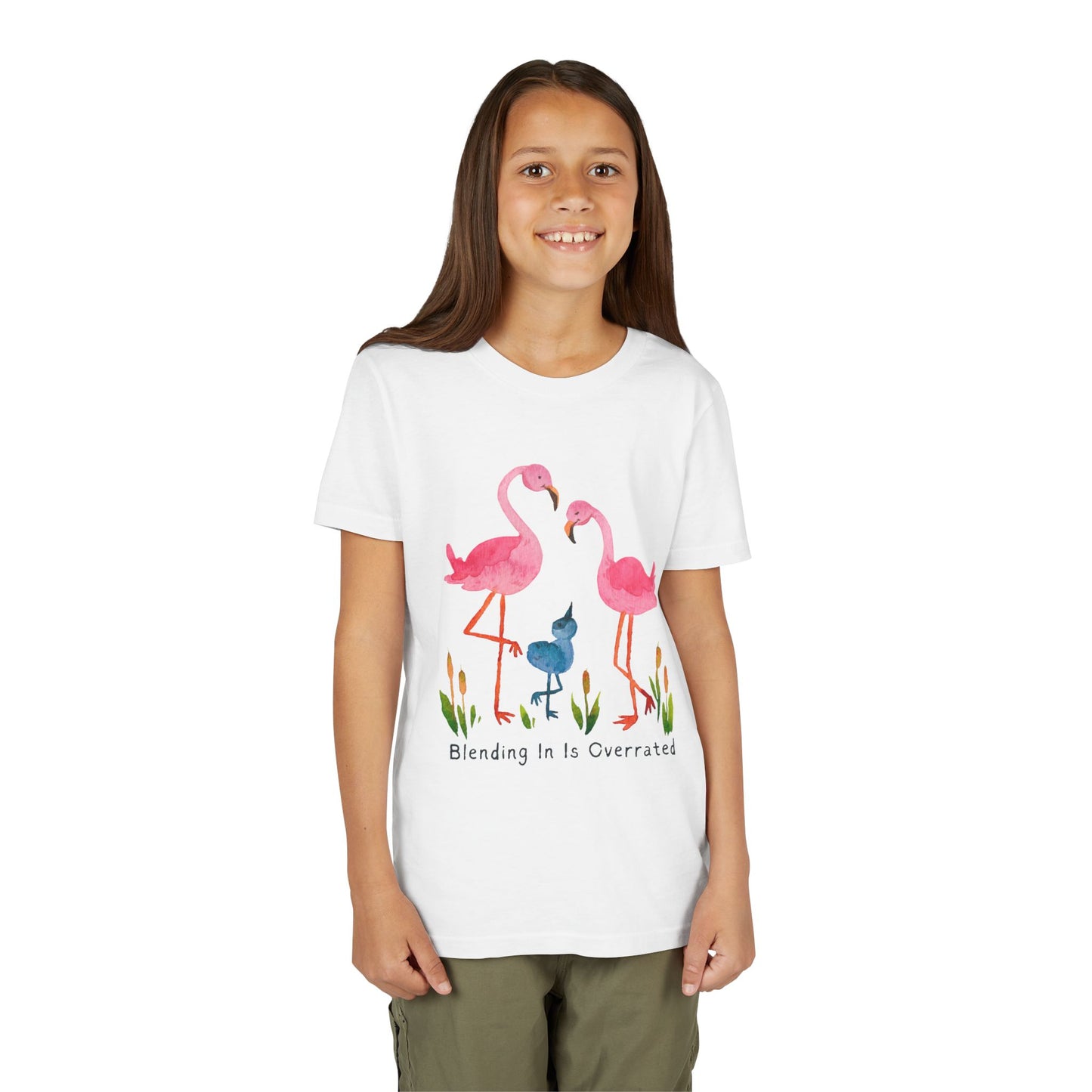 Girl wearing a white t-shirt with a flamingo family and text 'Blending In Is Overrated' 