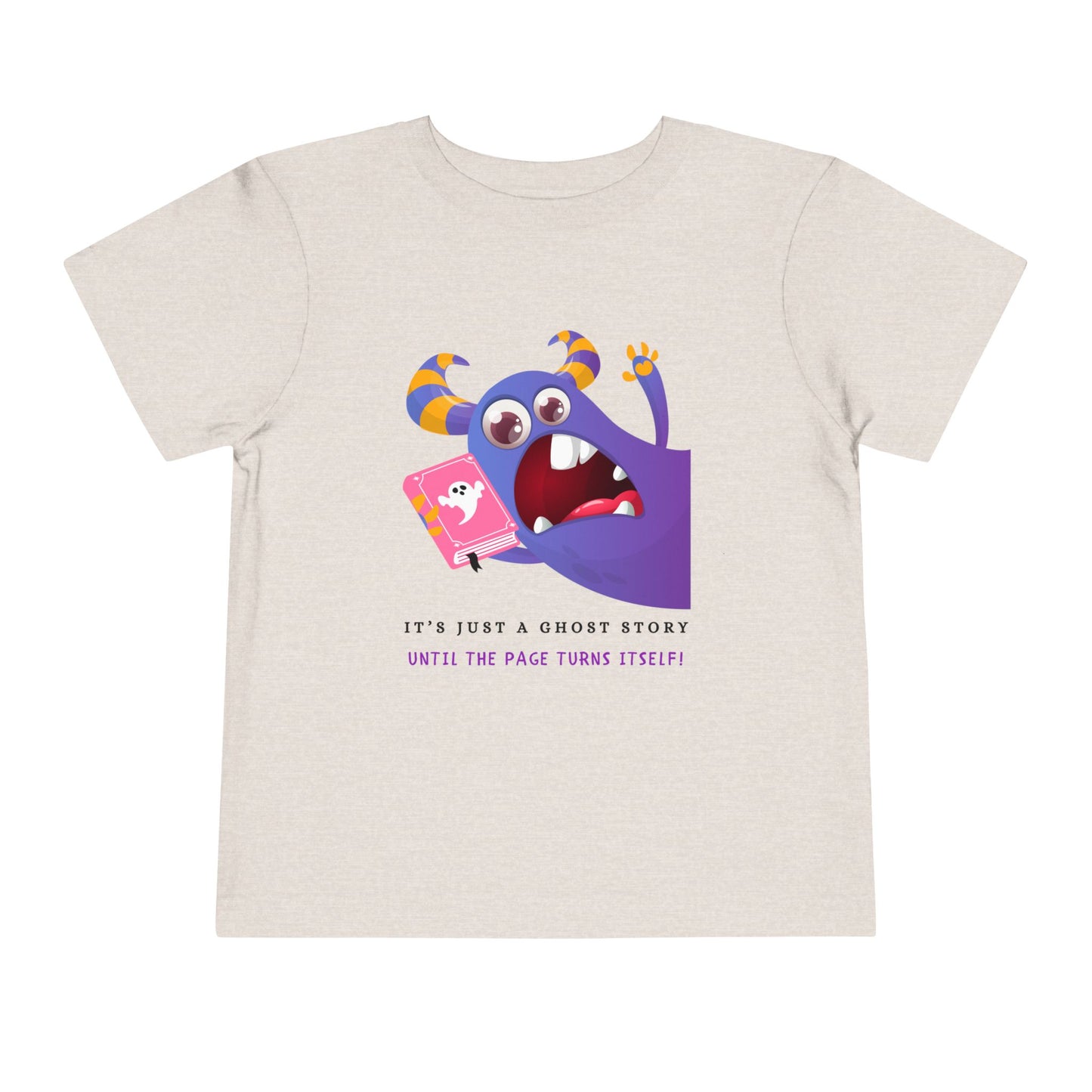 Beige toddler t-shirt with a scared purple monster holding a pink ghost book and text 'It's just a ghost story until the page turns itself!'