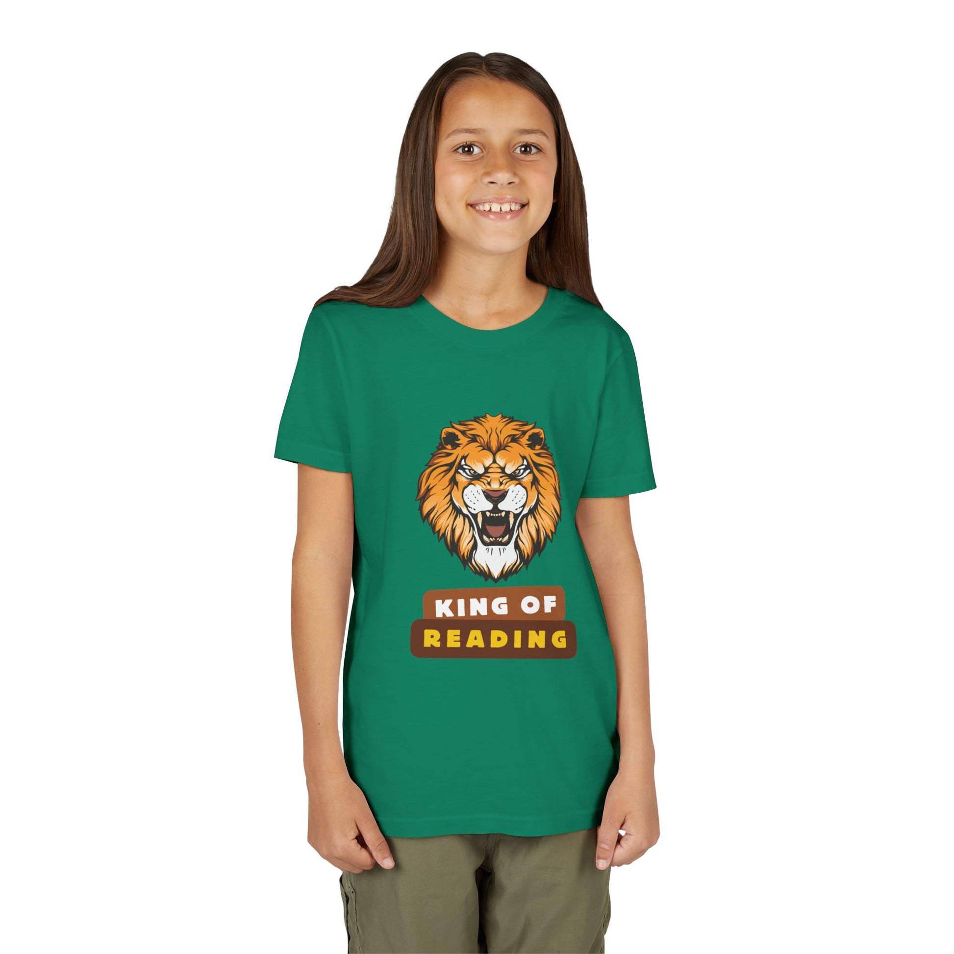 Girl wearing a green t-shirt with a roaring lion graphic and colorful 'King of Reading' text 