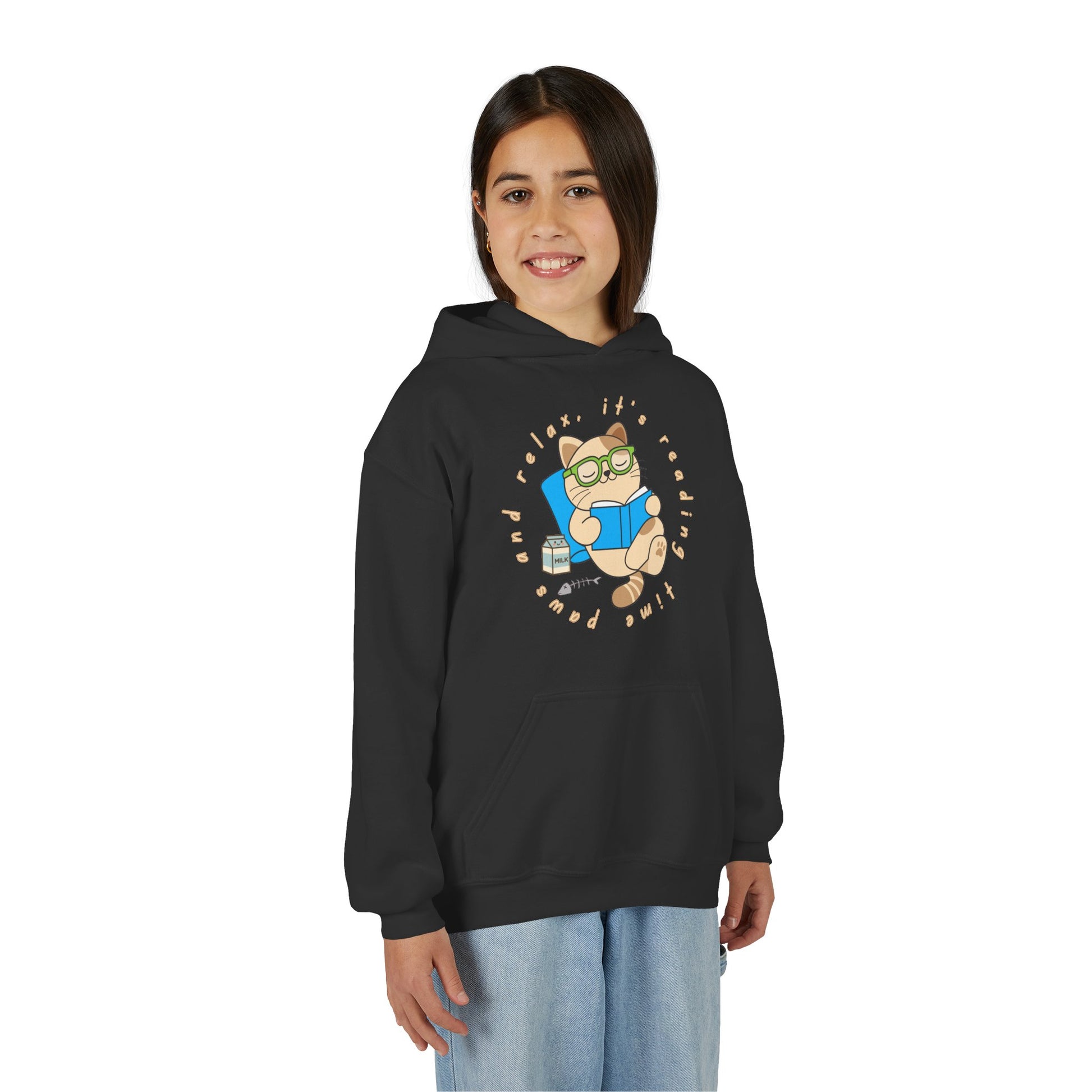 Girl wearing a black hoodie with a graphic of a cat reading a book and text 'Paws And Relax, It's Reading Time'
