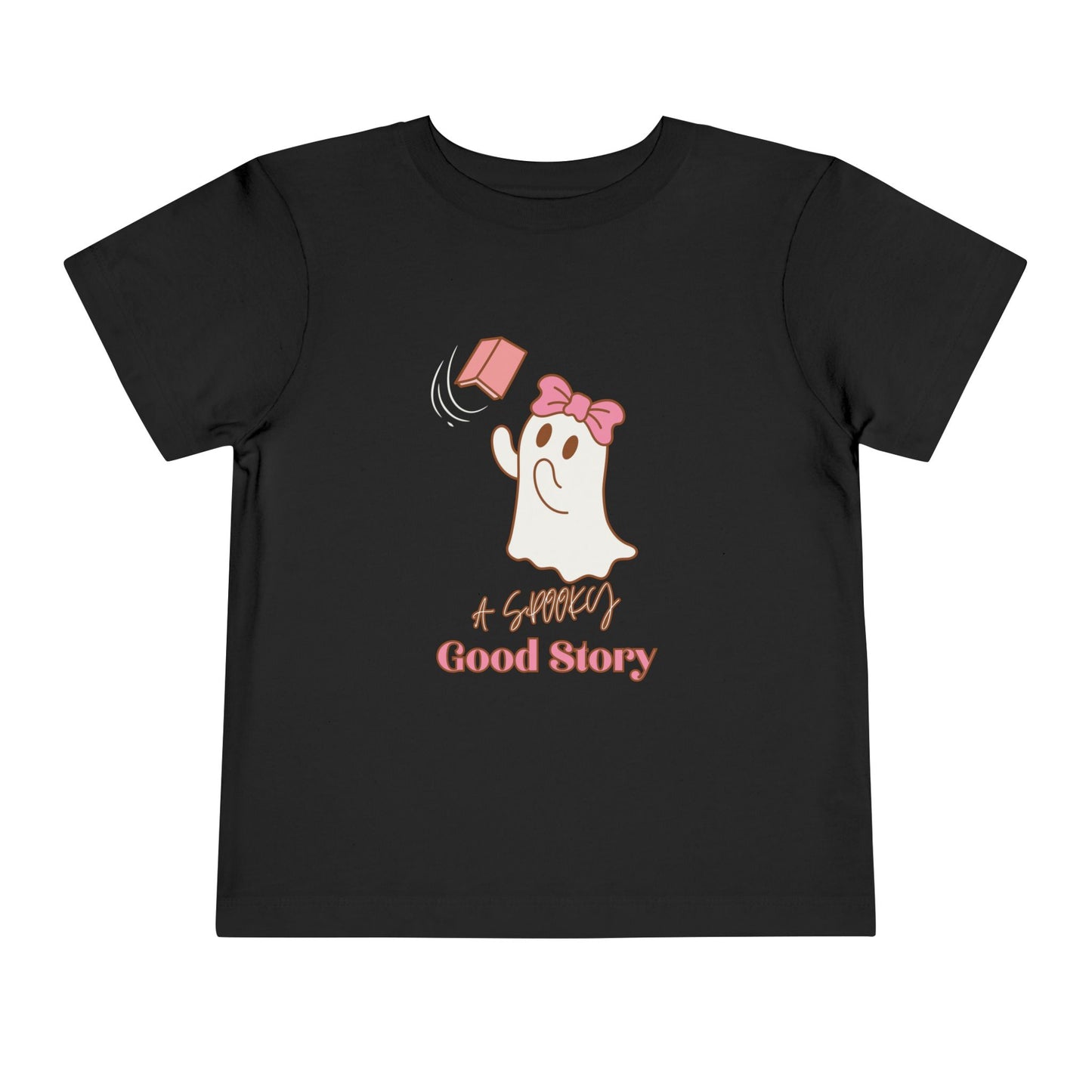 Black toddler t-shirt with a ghost trying to catch a floating pink book with text 'A SPOOKY GOOD STORY'