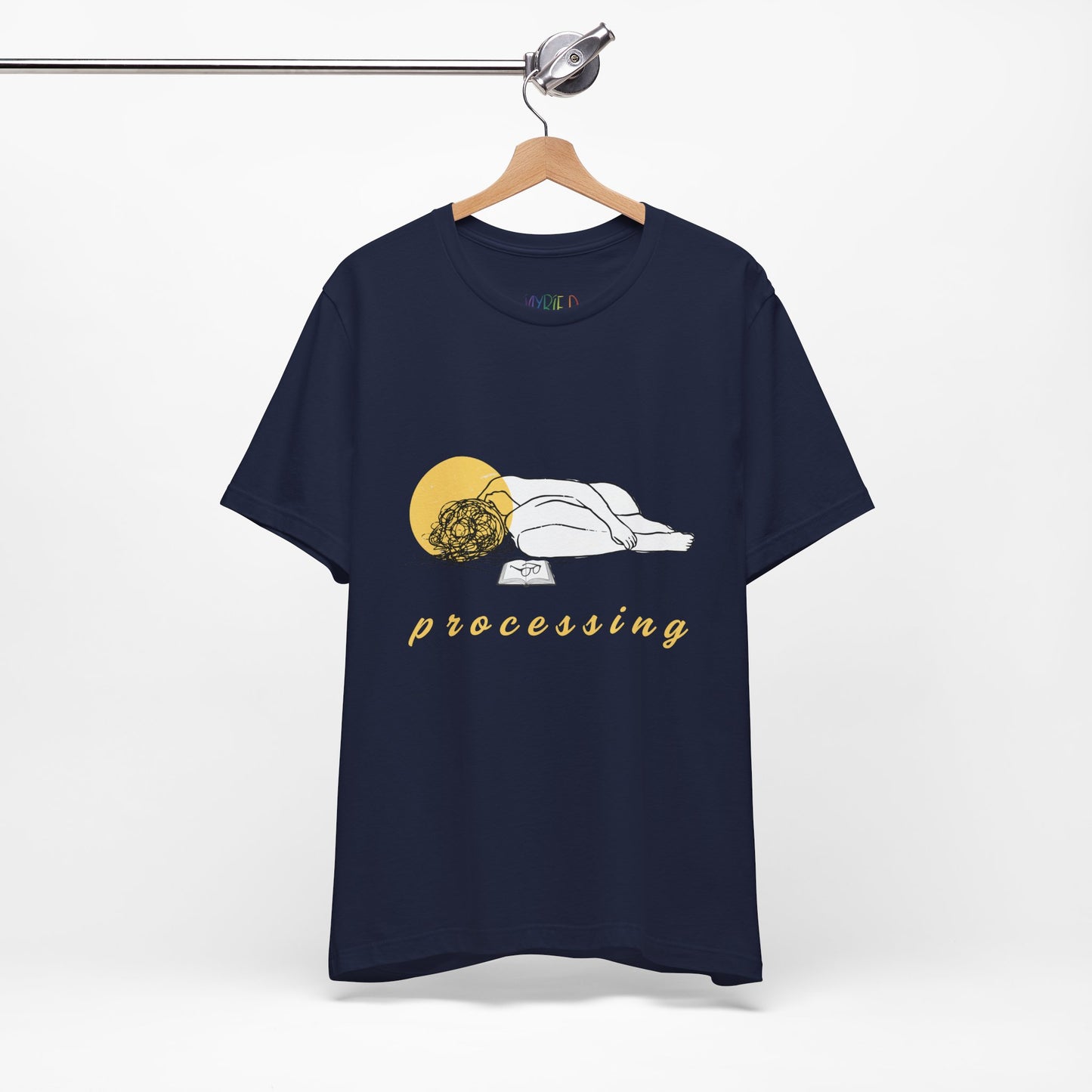 Navy blue t-shirt with person laying in a heap next to a book and 'processing' text 