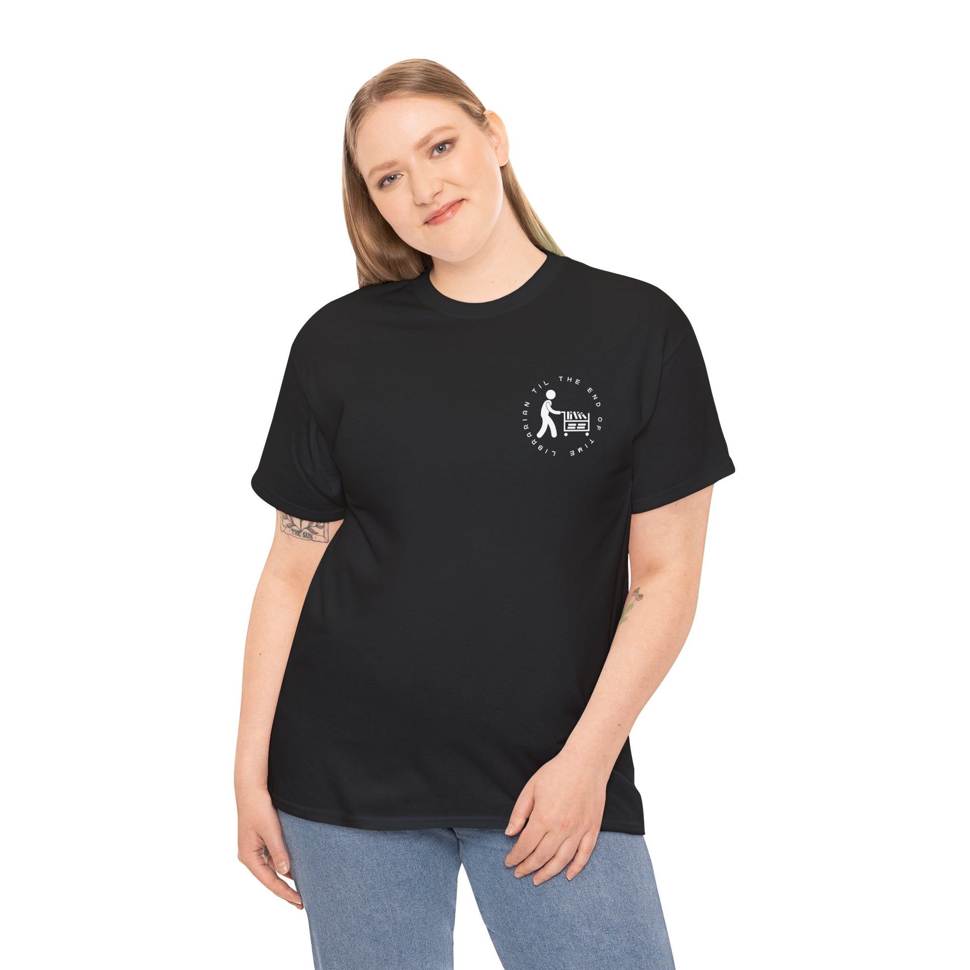 Woman wearing a black dual-sided t-shirt with a small librarian pushing a cart on the front and a full size bookshelf with a zombie hand reaching up on the back, text 'Late Fees Can't Stop Me'