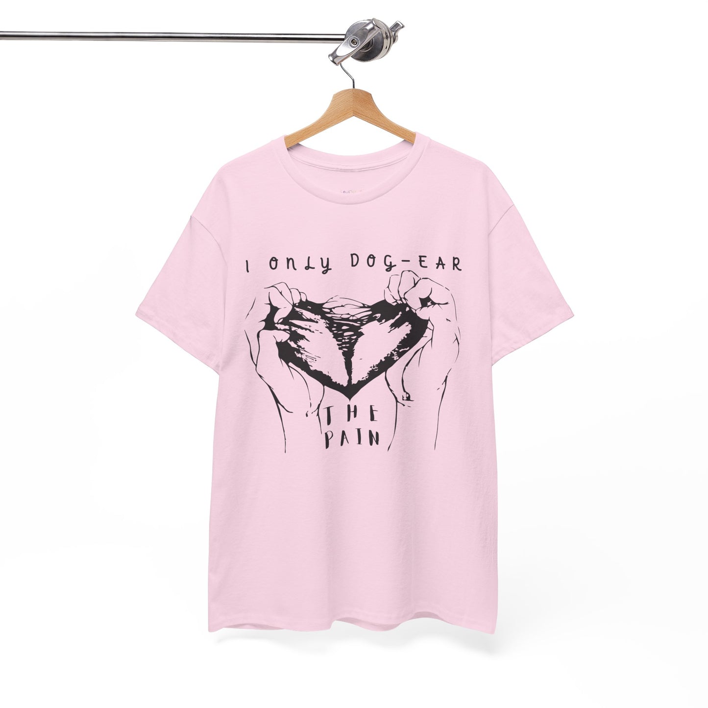 Pink t-shirt with black graphic of hands tearing apart a heart and text 'I Only Dog-Ear The Pain'