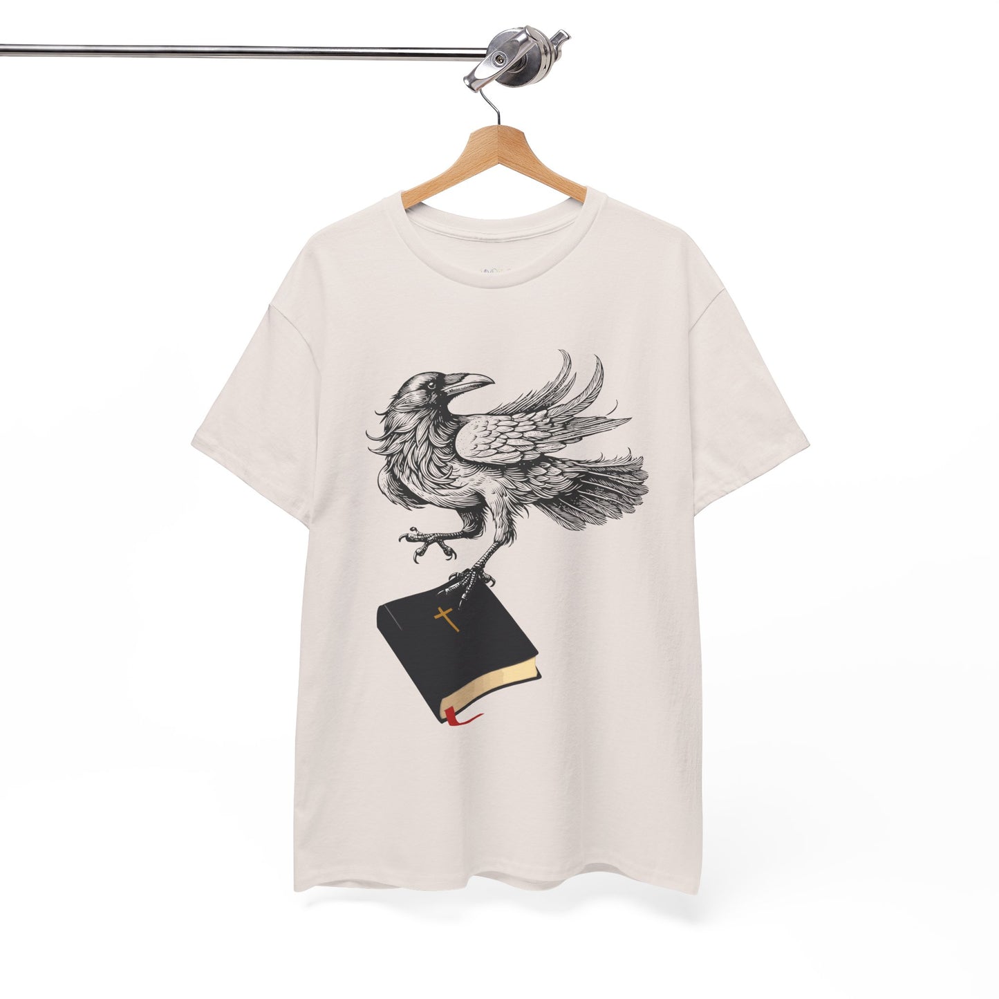 Beige t-shirt with a crow carying a bible, a shirt on a hanger against a white background