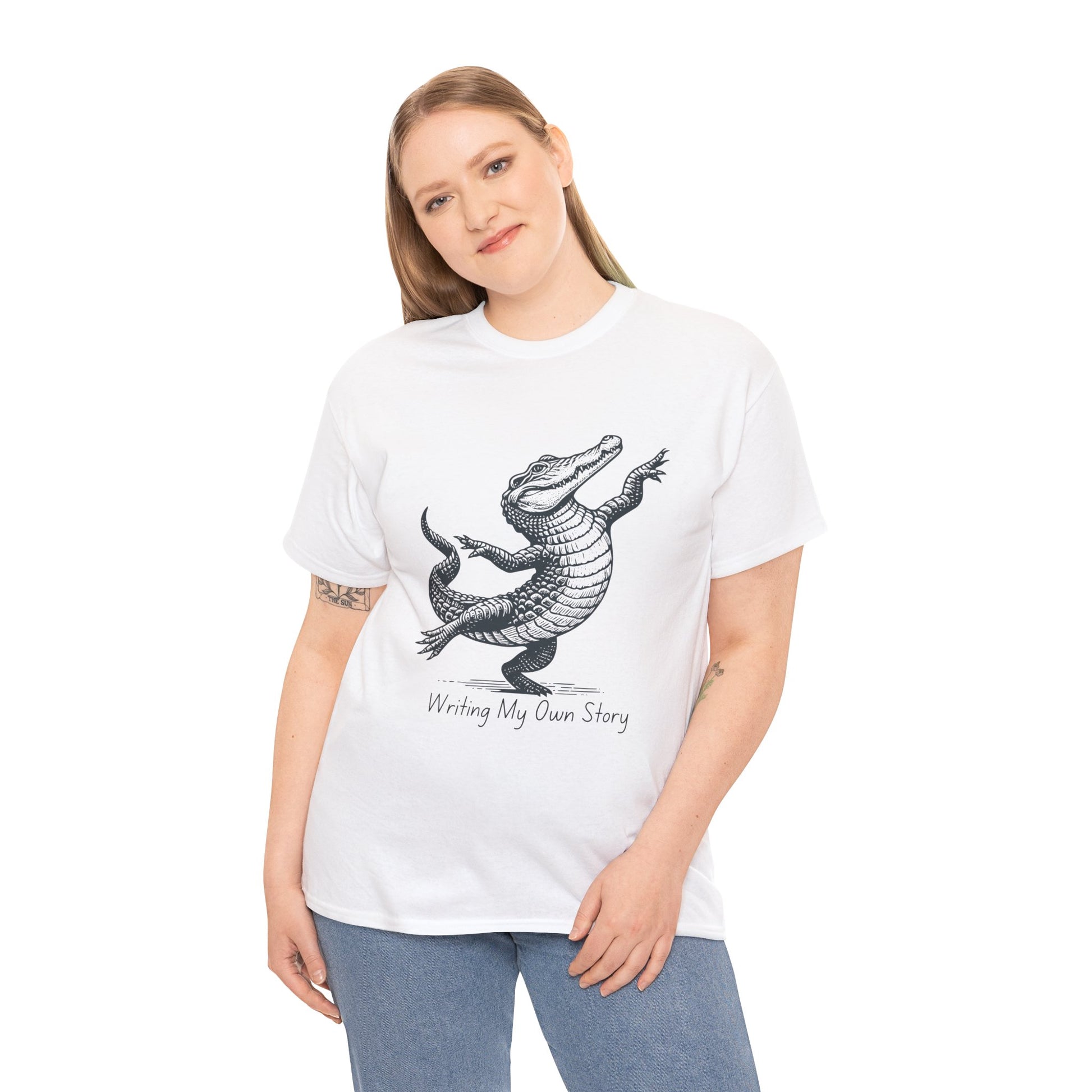 Woman wearing a white t-shirt with dancing alligator graphic and text 'Writing My Own Story' 