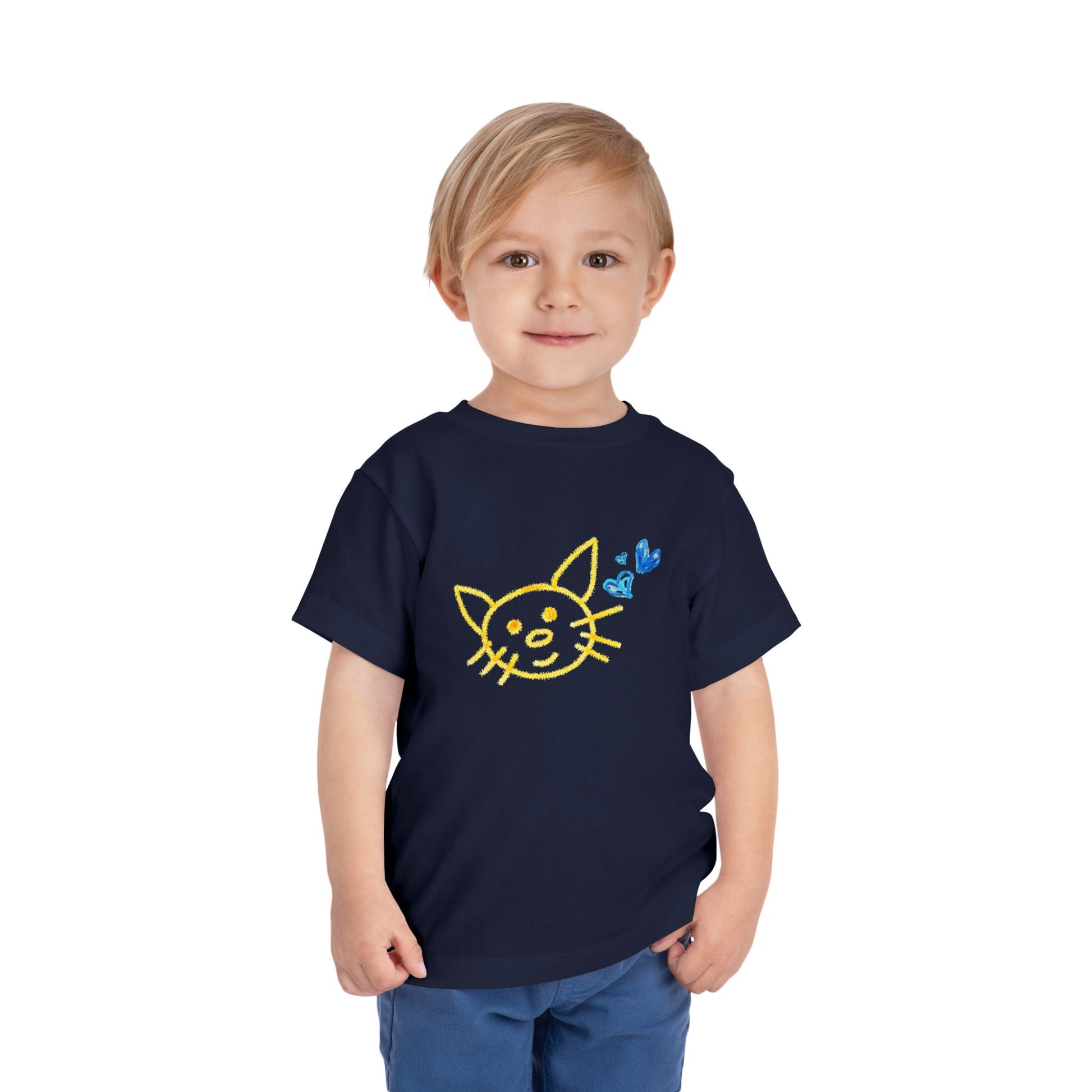 Child wearing a navy blue toddler t-shirt with a yellow and blue crayon drawing of a cat and hearts with a white background