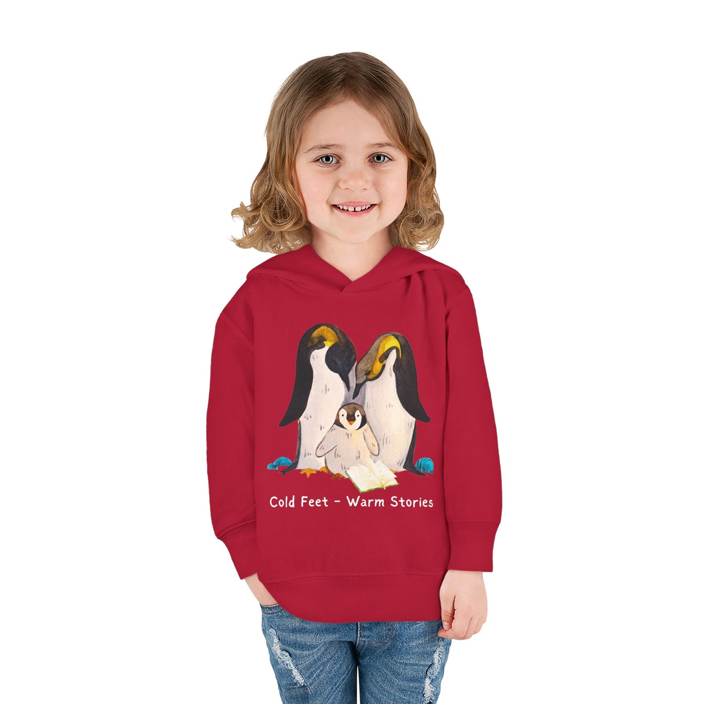 Girl wearing a red hoodie of a penguin family and text 'Cold Feet - Warm Stories'