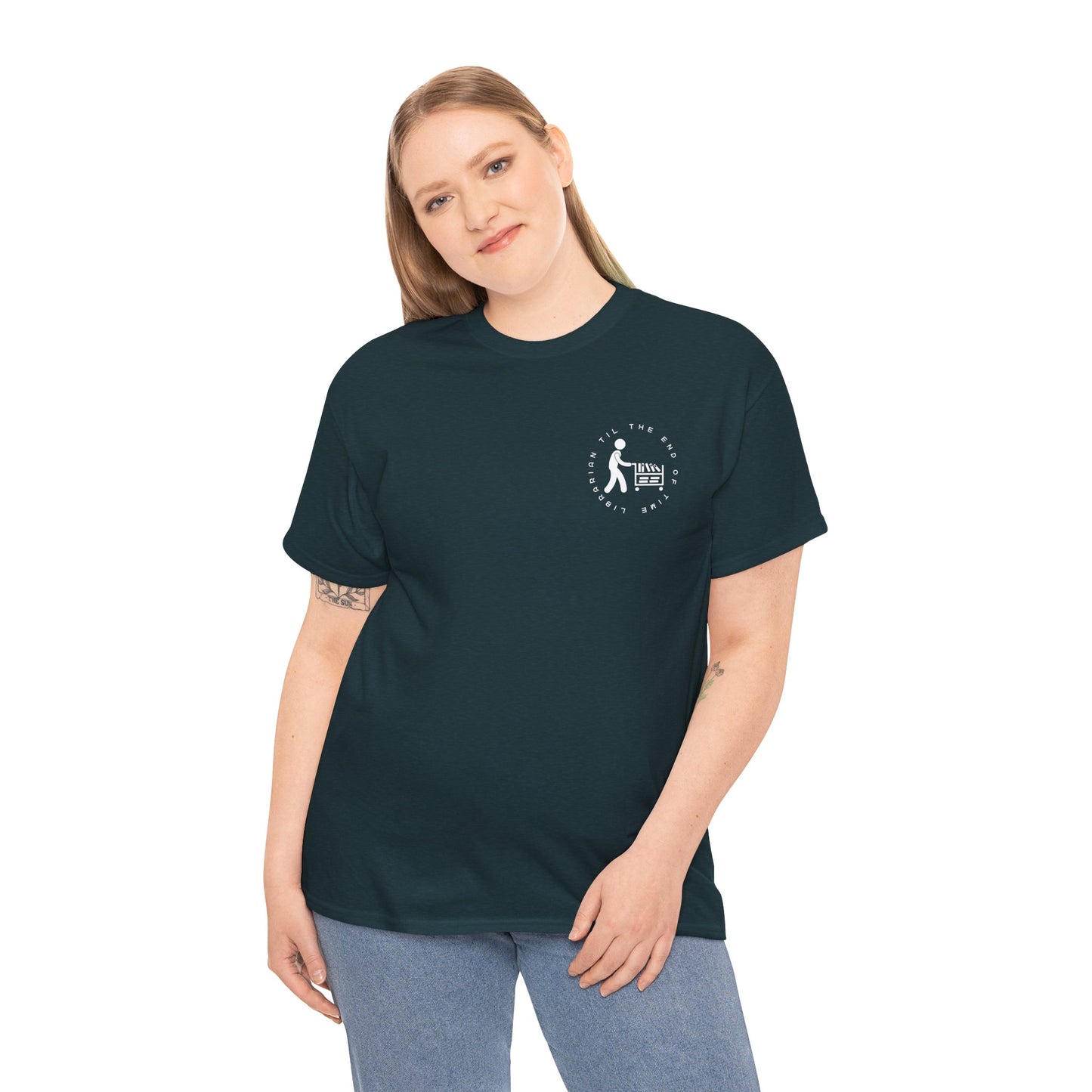 Woman wearing a midnight dual-sided t-shirt with a small librarian pushing a cart on the front and a full size bookshelf with a zombie hand reaching up on the back, text 'Late Fees Can't Stop Me'