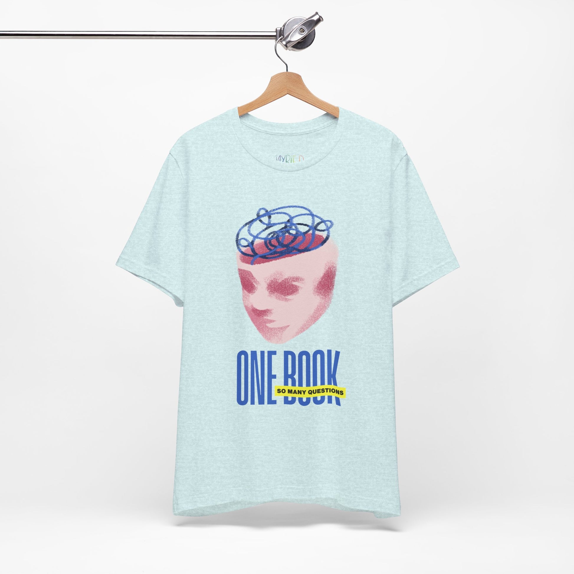 Light ice blue t-shirt with a pink face/head graphic, blue swirls coming out of the top and text 'One Book So Many Questions'