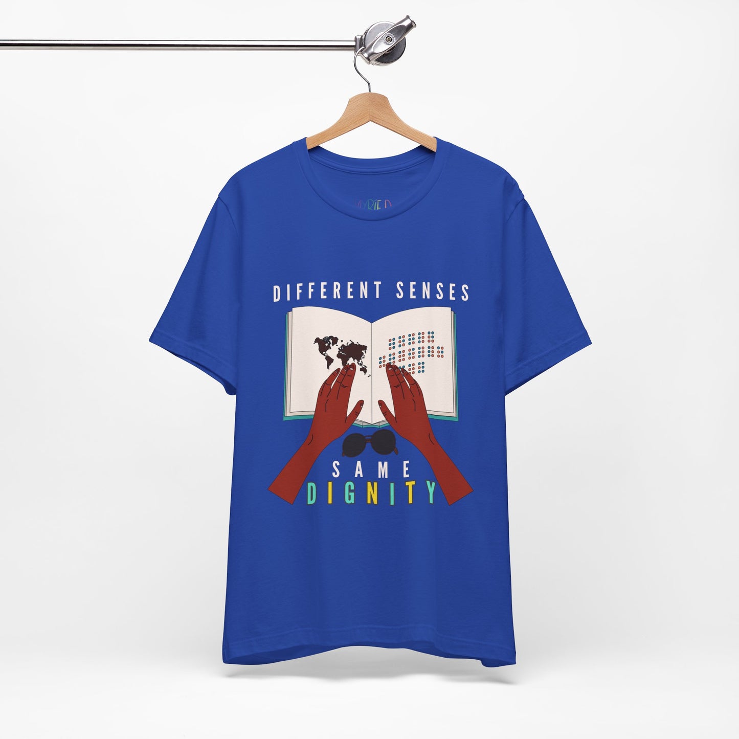 Blue t-shirt with graphic of two hands touching a braille book and text 'Different Senses, Same Dignity'