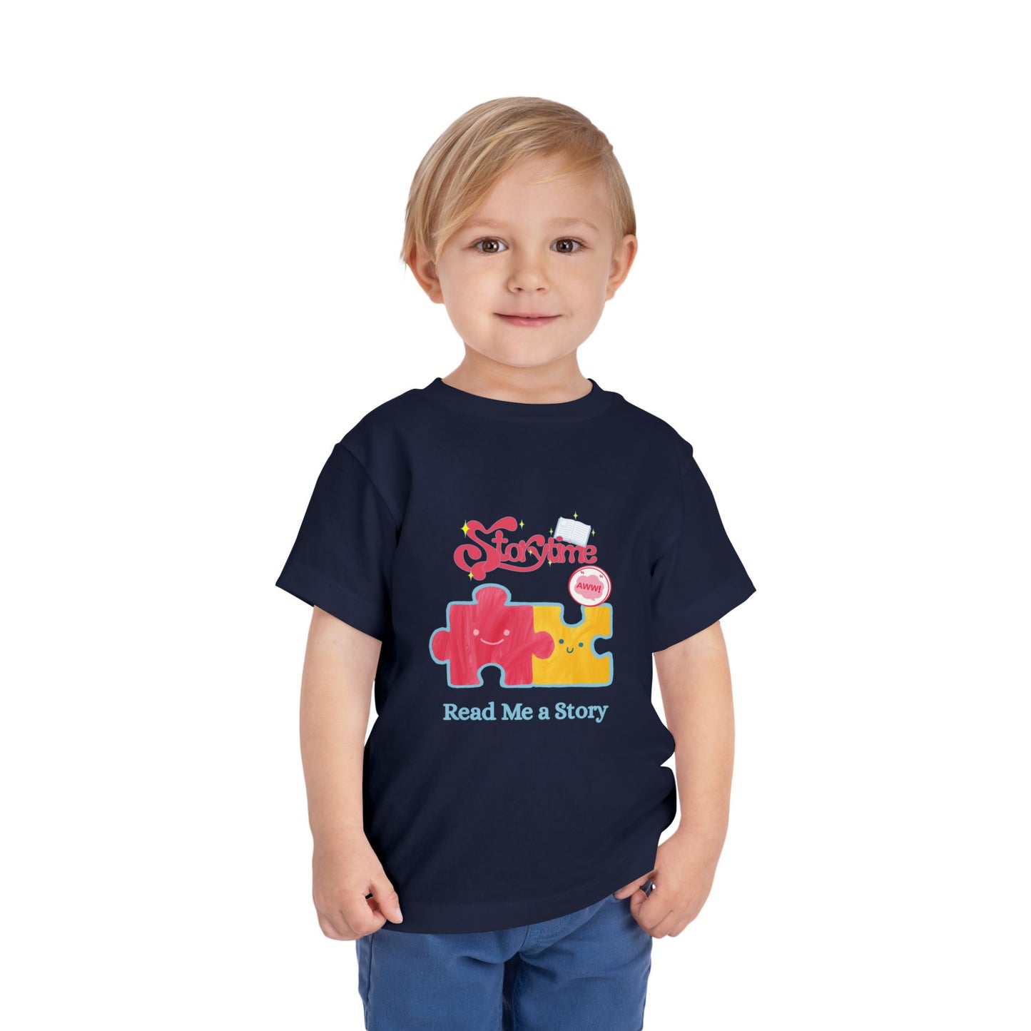 Child wearing a navy blue toddler t-shirt with colorful puzzle pieces and 'Read Me A Story' text 
