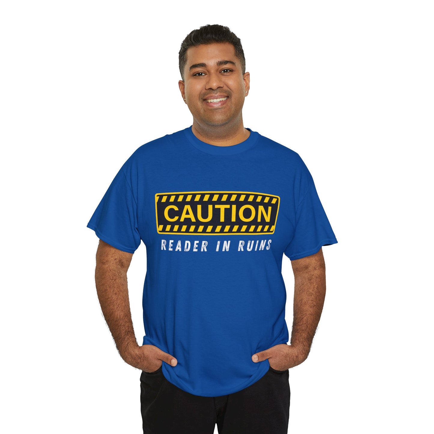 Man wearing a blue t-shirt with yellow and black 'Caution' graphic and text beneath ' Reader In Ruins'