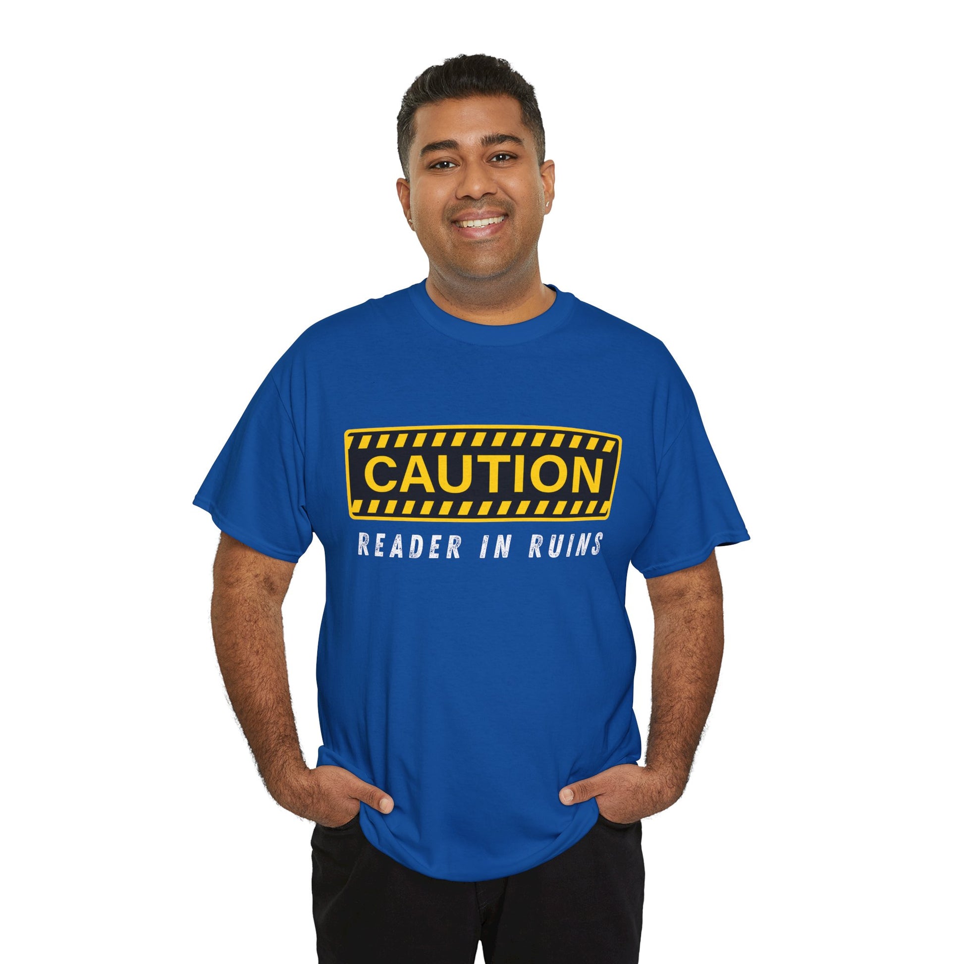 Man wearing a blue t-shirt with yellow and black 'Caution' graphic and text beneath ' Reader In Ruins'